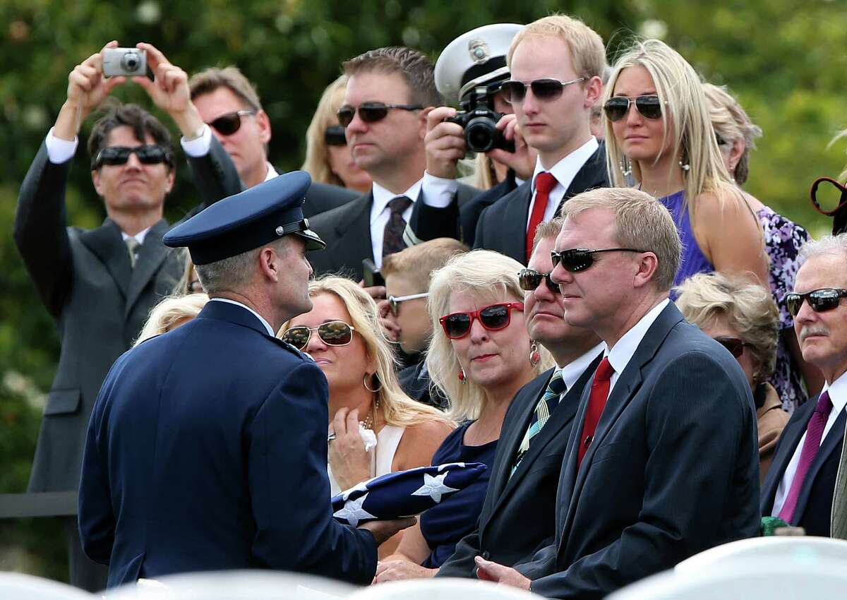 Jeffrey Walling receives the American flag that covered the casket of his father, U.S. Air Force Lt. Col. Charles M. Walling, from Air Force Chaplain Col. Charles Cornelisse during a burial service for Walling June 15, 2012 at Arlington National Cemetery in Arlington, Virginia. The plane carrying Lt. Col. Walling, of Phoenix, Arizona, crashed August 8, 1966 during a mission over Song Be Province, Vietnam. Walling's remains were located in 2010.