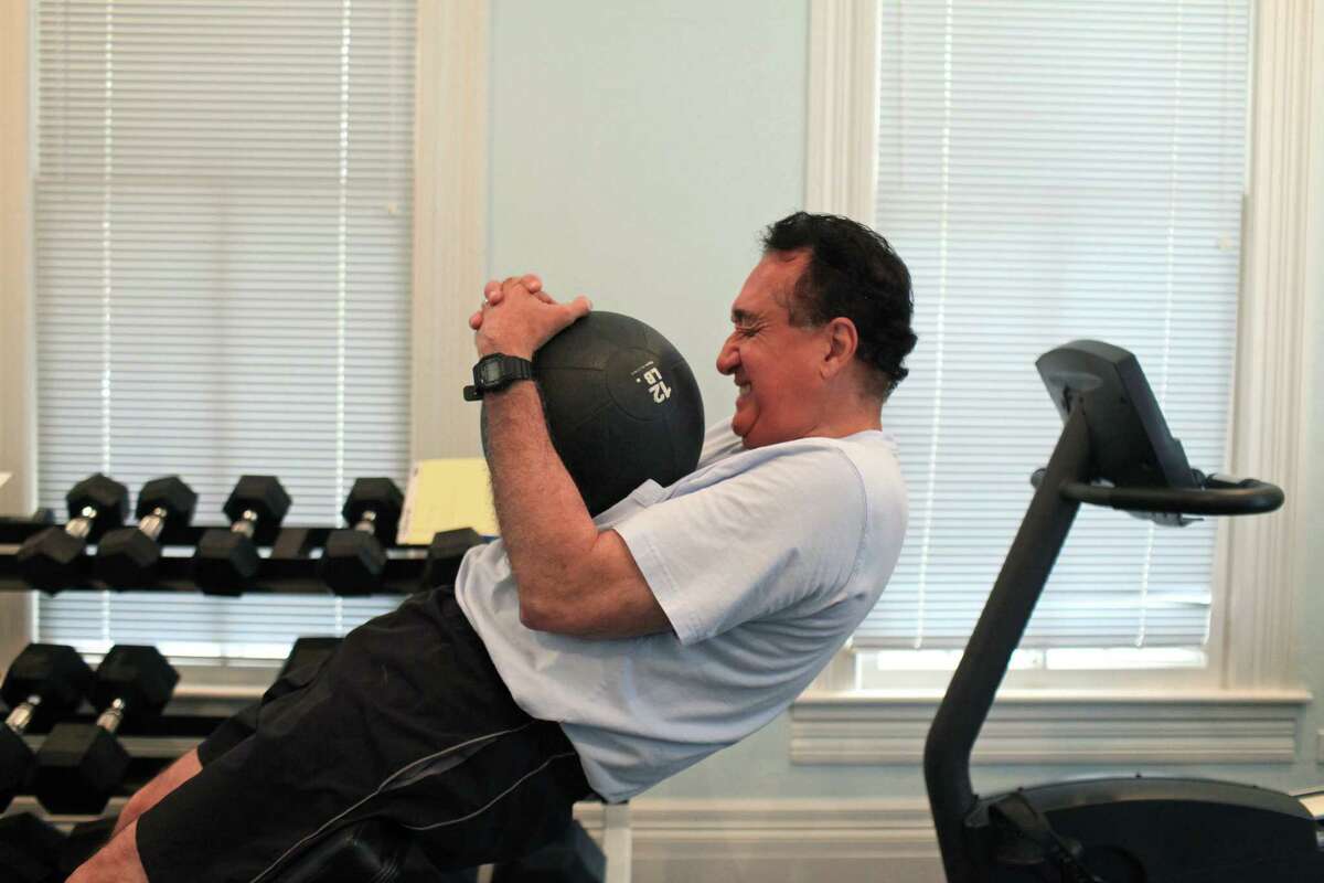 Henry Cisneros does his core routine as he exercises at his home on Tuesday, June 12, 2012. He alternates cardio and weights to exercise most days of the week.