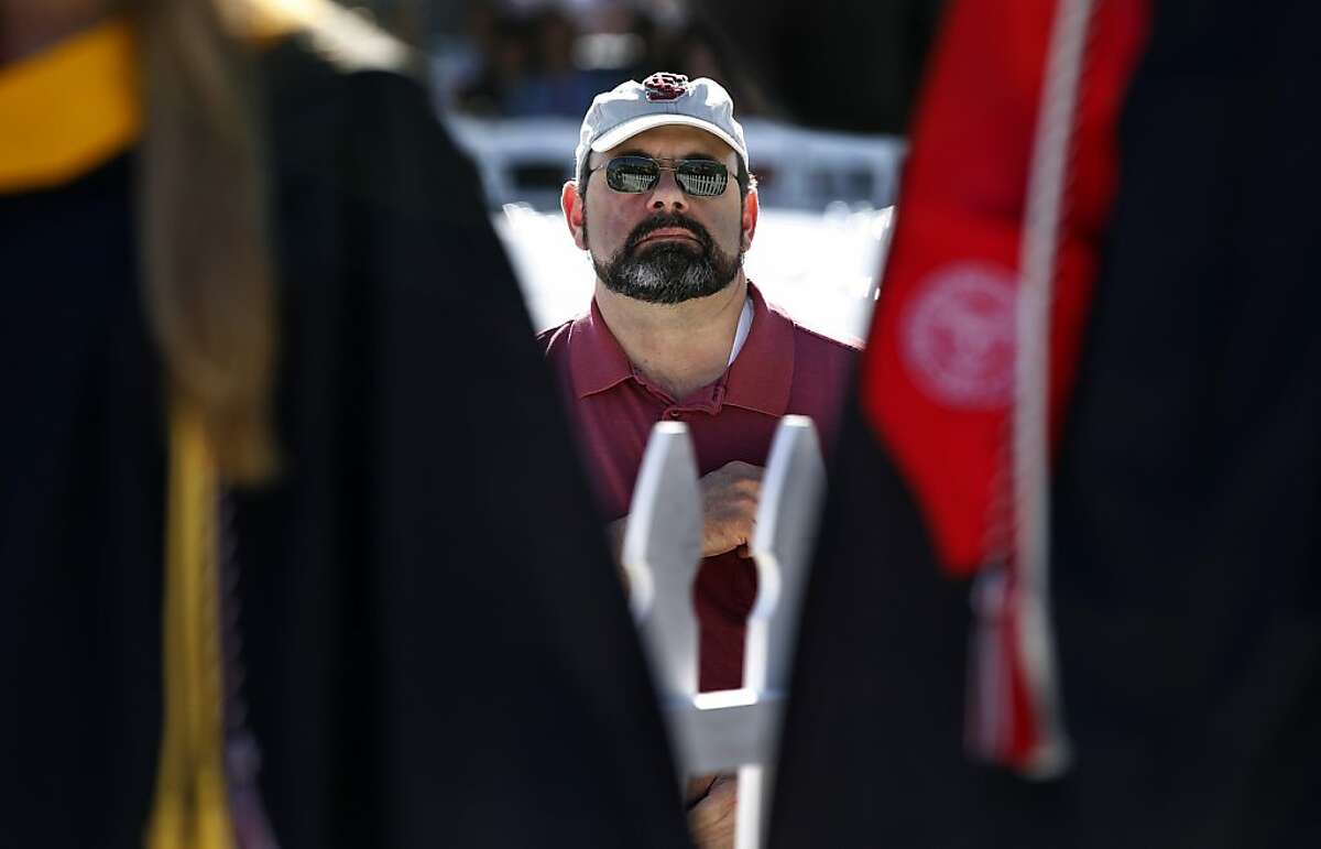 Rick Strickland watches graduates walk into Buck Shaw stadium for Santa Clara University commencement exercises in Santa Clara, Calif. on Saturday, June 16, 2012. Four engineeering students are continuing the alternative energy research that Strickland's son Dan was working on before his death in an auto accident last year.