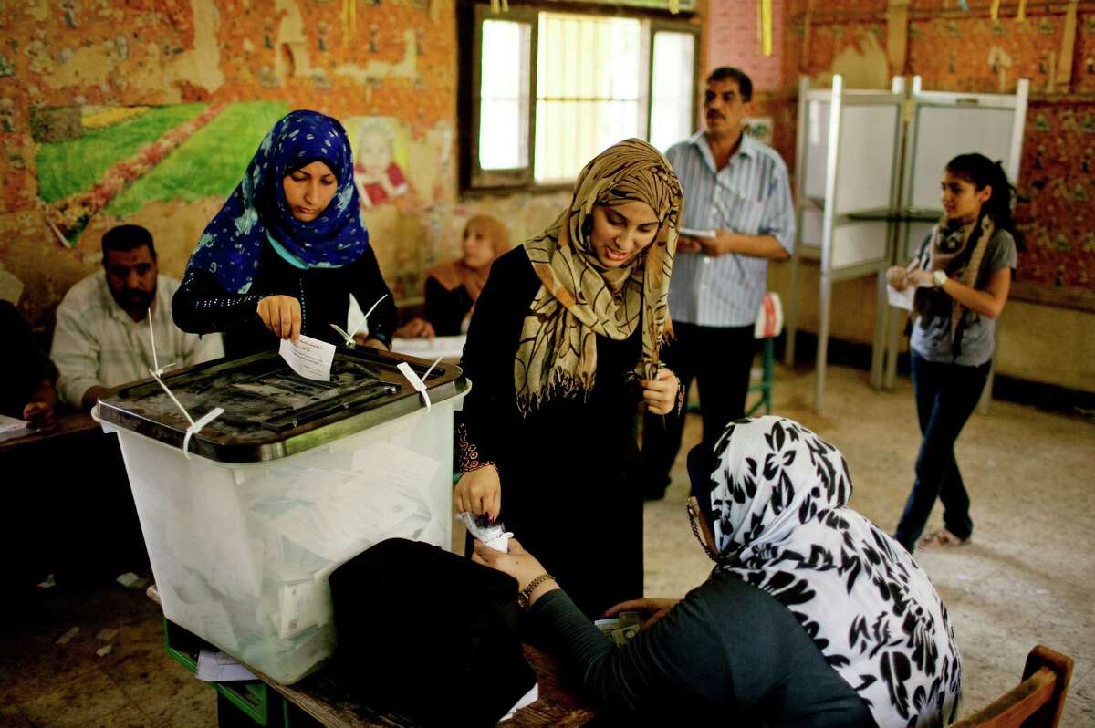Egyptian women vote at a polling station in Shubrah El-Kheima, a working class, industrial area on the outskirts of Cairo, Egypt on Saturday, June 16, 2012. Egyptians voted Saturday in the country's landmark presidential runoff, choosing between Hosni Mubarak's ex-prime minister and an Islamist candidate from the Muslim Brotherhood after a race that has deeply polarized the nation. The two-day balloting will produce Egypt's first president since a popular uprising last year ousted Mubarak, who is now serving a life sentence.