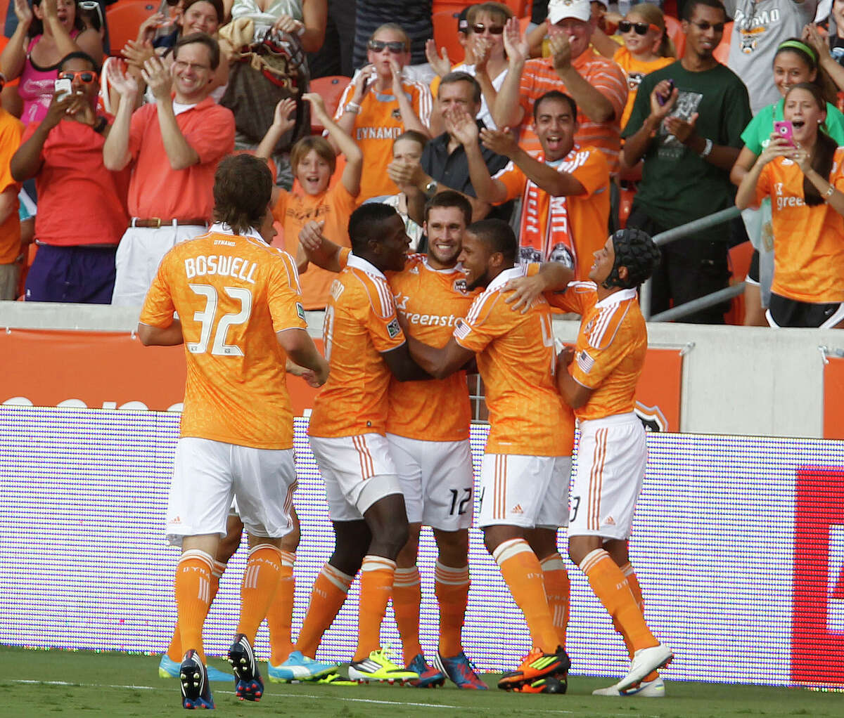 The Houston Dynamo forward Will Bruin center, celebrates with teammates after scoring a goal against FC Dallas during the first half of MLS game action at BBVA Compass Stadium Saturday, June 16, 2012, in Houston.