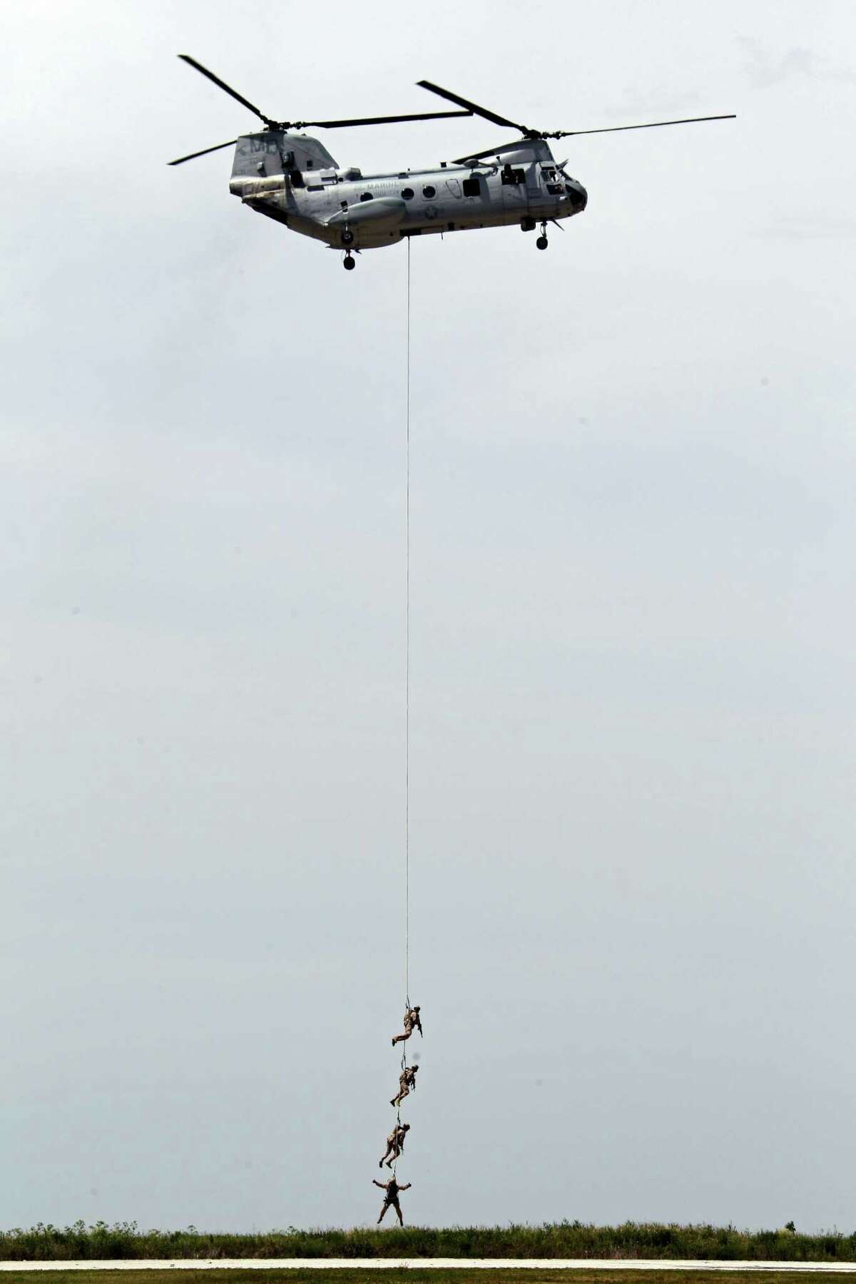 Four Marines are lifted off Burke Lakefront Airport in Cleveland by a CH-46 helicopter during a combat demonstration on Saturday, June 16, 2012, during Marine Week festivities in the city.