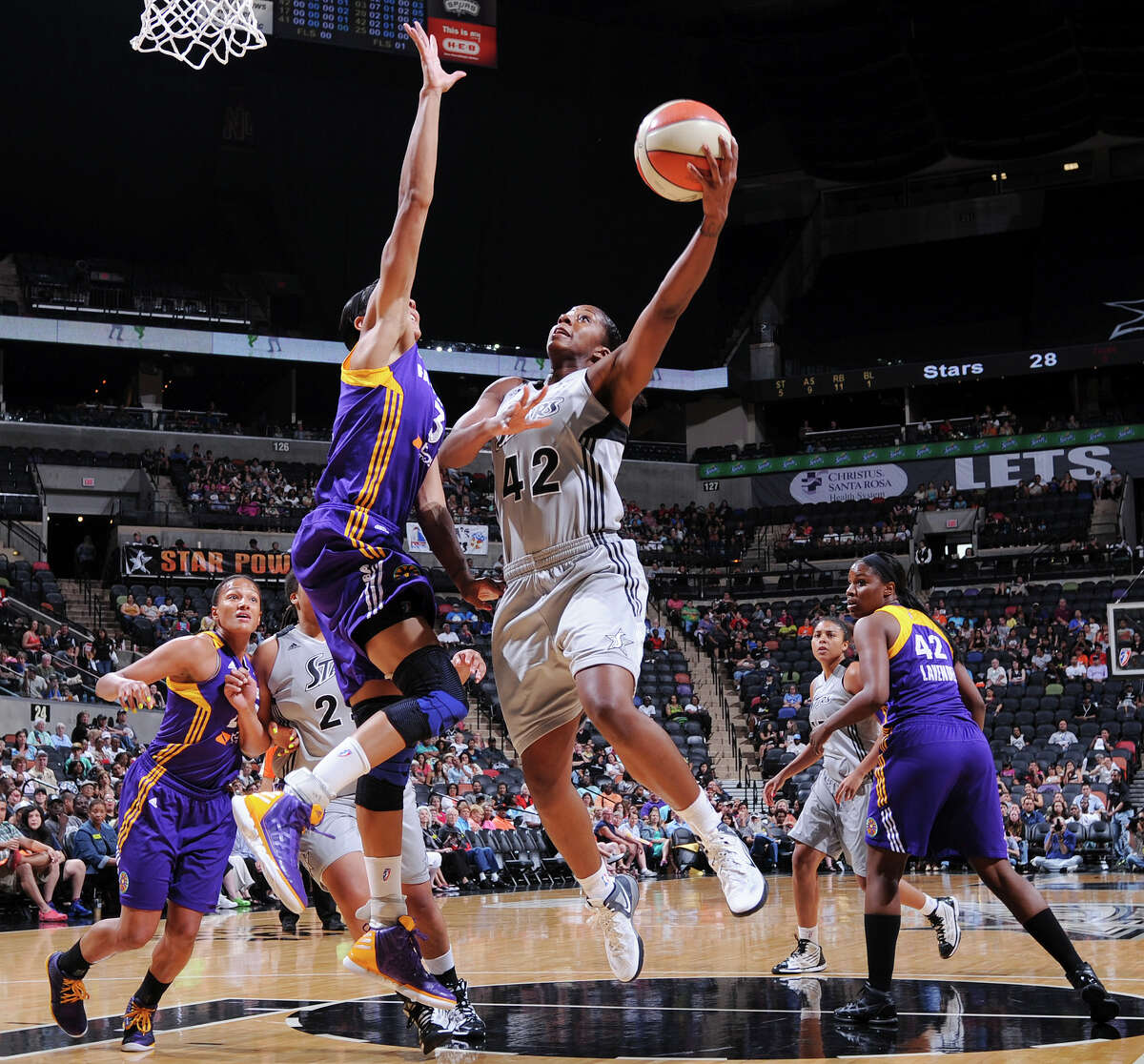 The Silver Stars' Shenise Johnson shoots around Sparks' Candace Parker during first half action Saturday, June 16, 2012 at the AT&T Center.