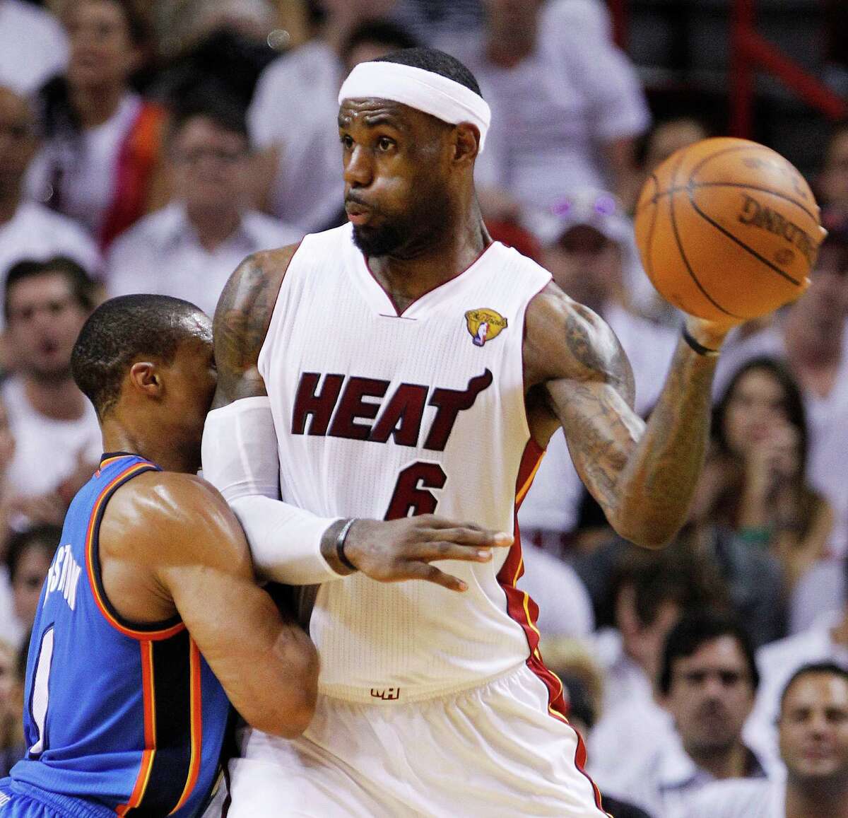 Miami Heat small forward LeBron James (6) looks to pass against Oklahoma City Thunder point guard Russell Westbrook (0) during the second half at Game 3 of the NBA Finals basketball series, Sunday, June 17, 2012, in Miami. (AP Photo/Lynne Sladky)