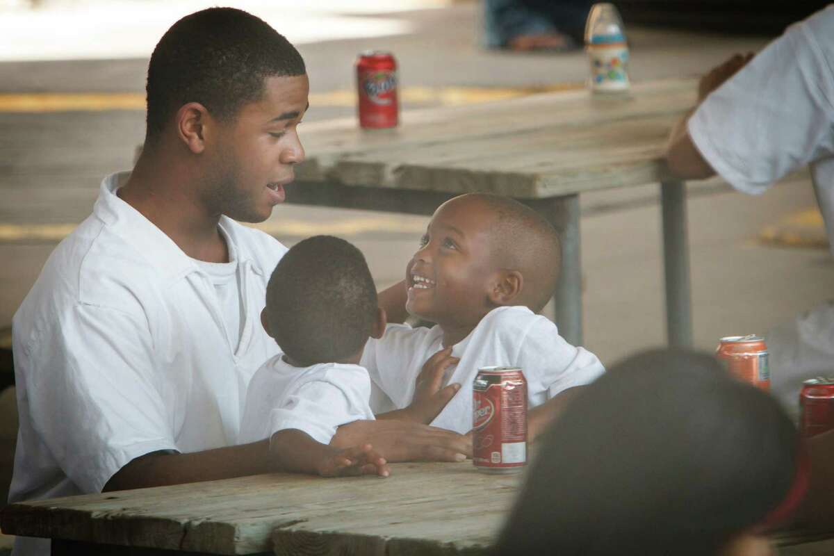 Dexter St. Andre appears happy to see his two sons, Dexter Jr., 1, left, and Dyzmond, 3.