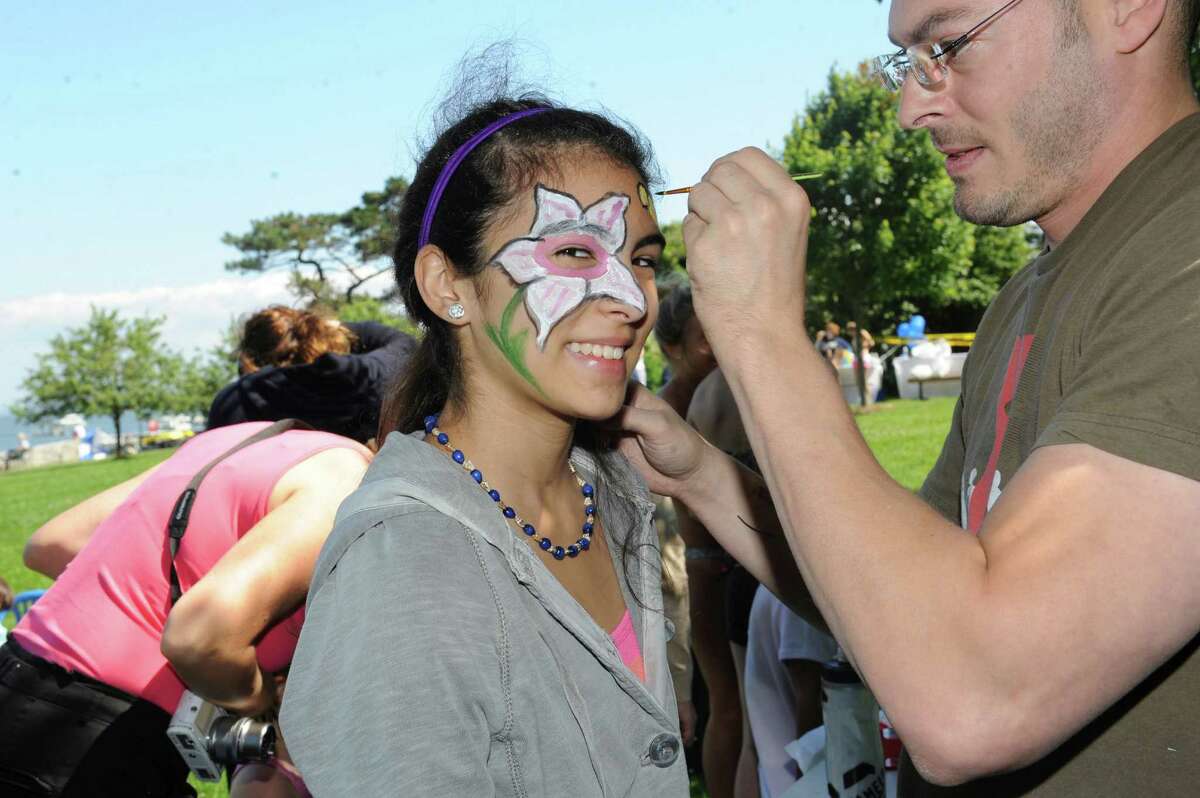 Sophia Amaerillo, 13, has her face painted by Michael Fareri at the Greenwich Family Fair in Byram Park hosted by Junior League of Greenwich Sunday, June 17, 2012. In cooperation with the town, the Junior League is working to build a new community pool in Byram Park.
