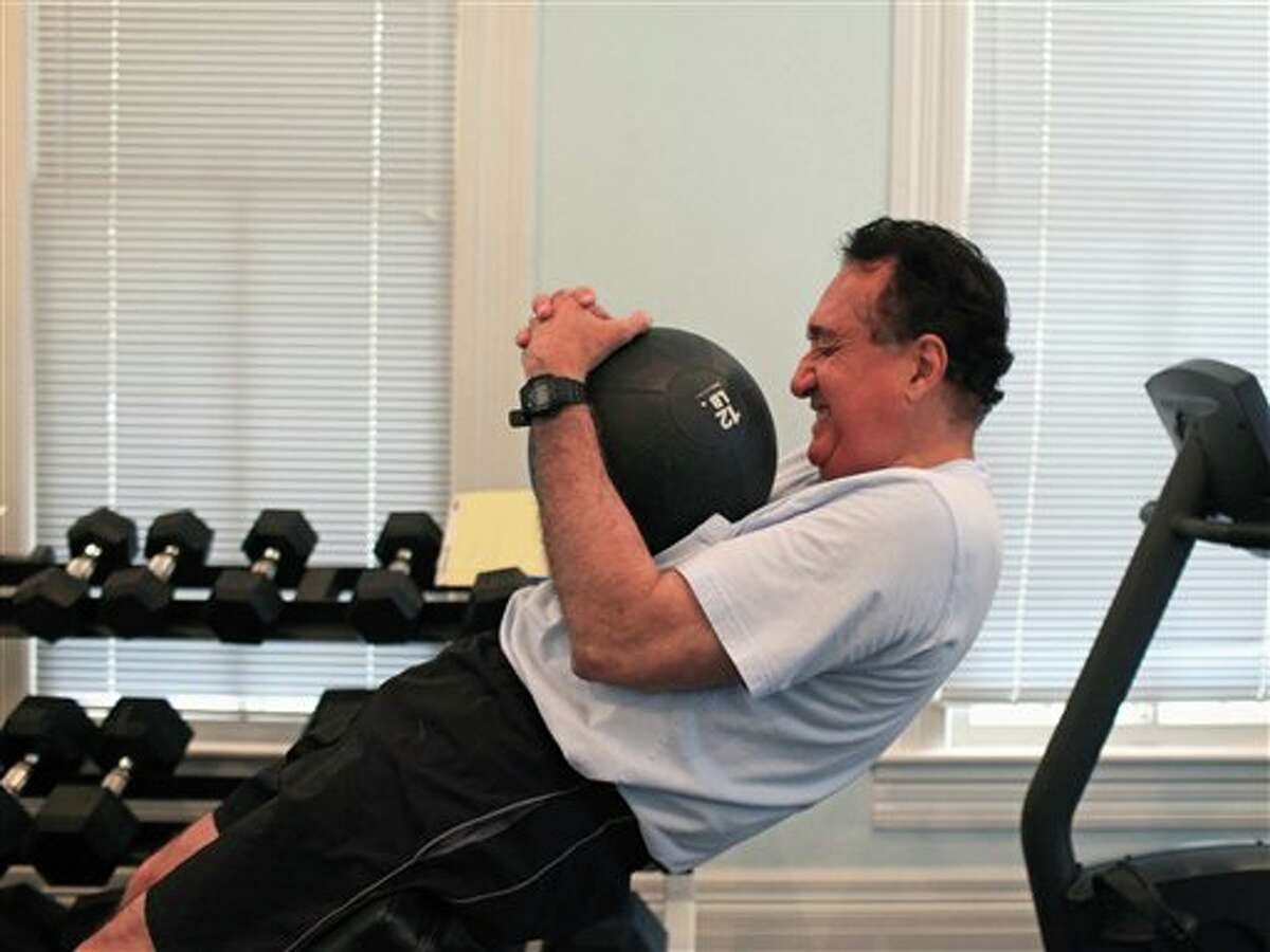 In this June 12, 2012, photo, Henry Cisneros does his core routine as he exercises at his home in San Antonio. Cisneros, who served as housing secretary under President Bill Clinton, says he has been diagnosed with early-stage prostate cancer but expects to beat the disease with nine weeks of radiation therapy.