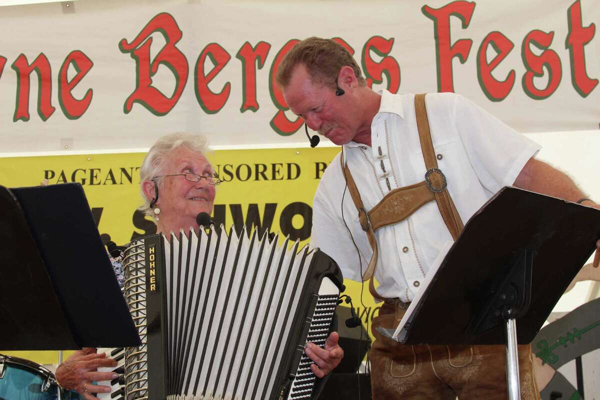 Accordion-playing 'Oma' Pearly Sowell gets birthday wishes from her son, David Smith, while playing at Berges Fest. The two are the core of New Braunfels' Oma and the Oompahs.