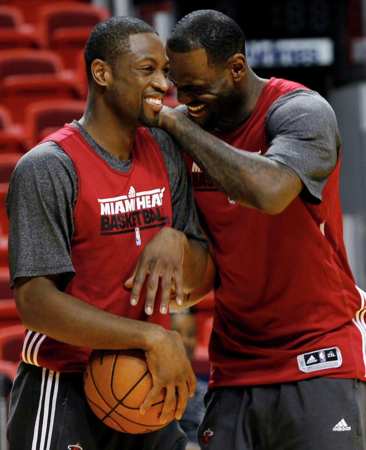 Miami Heat shooting guard Dwyane Wade, left, and small forward LeBron James share a laugh during practice, Monday, June 18, 2012, in Miami. The Heat play the Oklahoma City Thunder in Game 4 of the NBA basketball finals on Tuesday. (AP Photo/Alan Diaz)