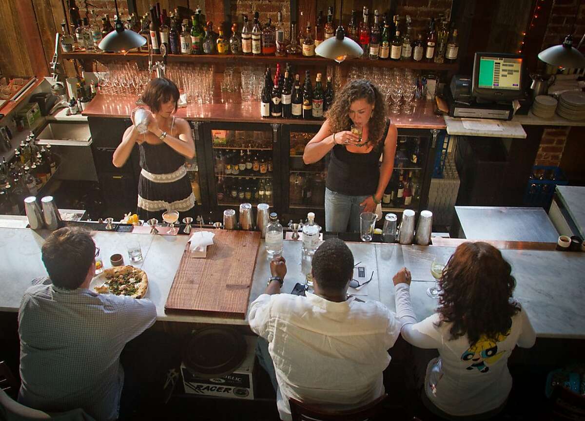 Bartenders make drinks for customers at Boot and Shoe Service restaurant in Oakland, Calif., on September 7th, 2011.