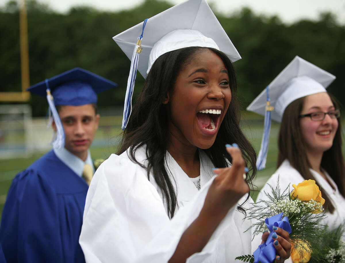 Naomi Georges breaks into a big smile as she marches in with her fellow graduates to the Frank Scott Bunnell High School graduation exercises in Stratford on Tuesday, June 19, 2012.