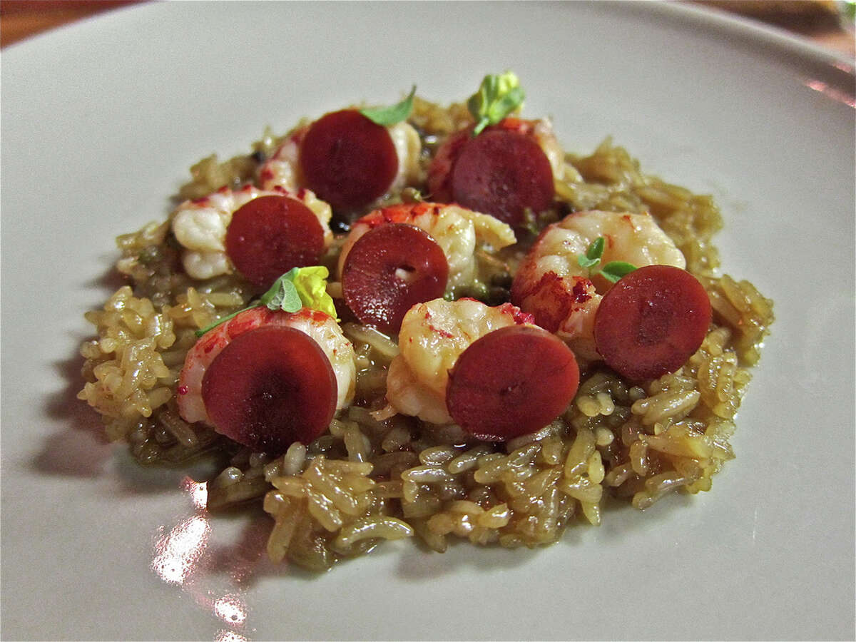 Crawfish poached in butter with fermented carrot, green coriander seeds and Texas rice as served at Oxheart.