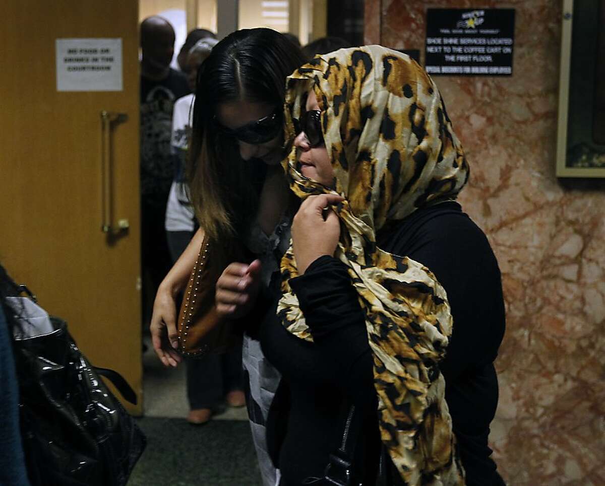 Unidentified supporters leave Judge Samuel Feng's courtroom after attending the arraignment for Barry Gilton and Lupe Mercado at the Hall of Justice in San Francisco, Calif. on Wednesday, June 20, 2012. The couple are accused of killing a man who they believe was their 17-year-old daughter's pimp.