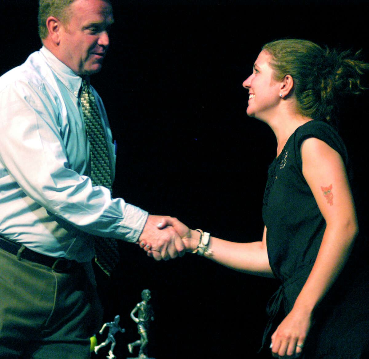 Scholar-athlete New Milford High School senior Faith Eherts is congratulated Monday by Green Wave girls' lacrosse coach Bill Kersten as the team's scholar-athlete for this spring. Faith and her fellow Green Wave student athletes were honored during the school's annual spring sports awards ceremony. For the story and more photos, see next week's Greater New Miford Spectrum and check www.newmifordspectrum.com.