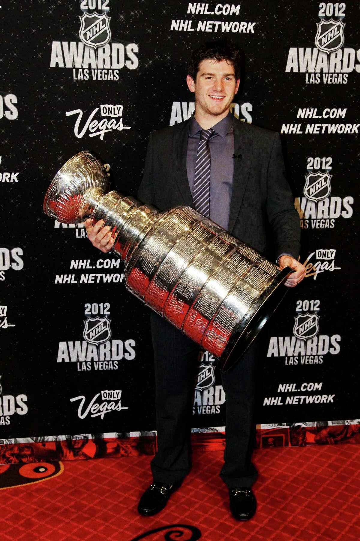Kings goaltender Jonathan Quick shows off the Stanley Cup at the NHL Awards ceremony in Las Vegas.