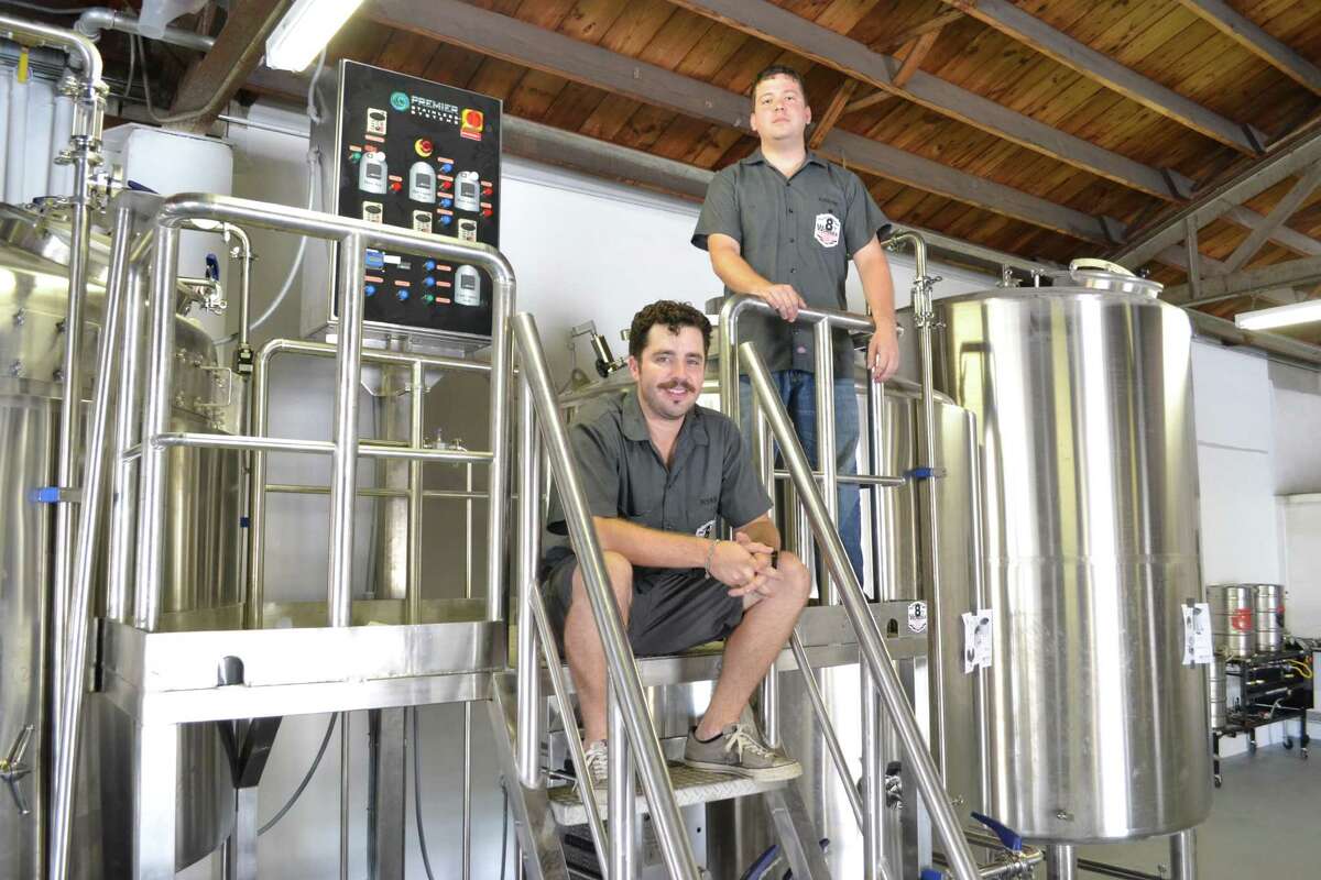 Ryan Soroka, left, and brewer Aaron Corsi of the 8th Wonder Brewing Co. in EaDo passed another milestone toward opening by installing this automated, 20-barrel brewhouse.