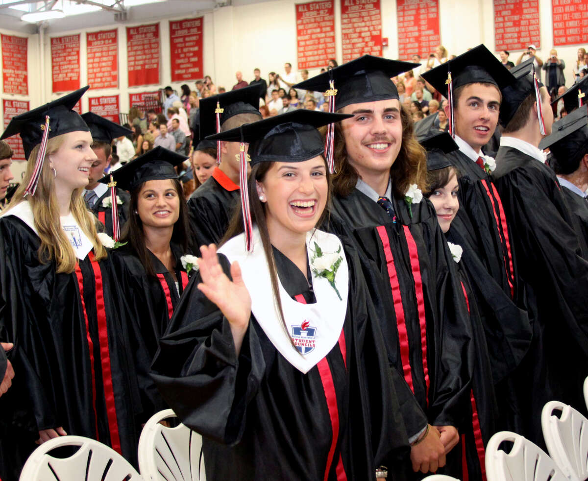 Julia Cipriano waves to the crowd as classmate Peter Cimmino looks on during graduation exercises held at Pomperaug Regional High School on June 20, 2012 in Southbury, CT. Photo taken June 20, 2012.