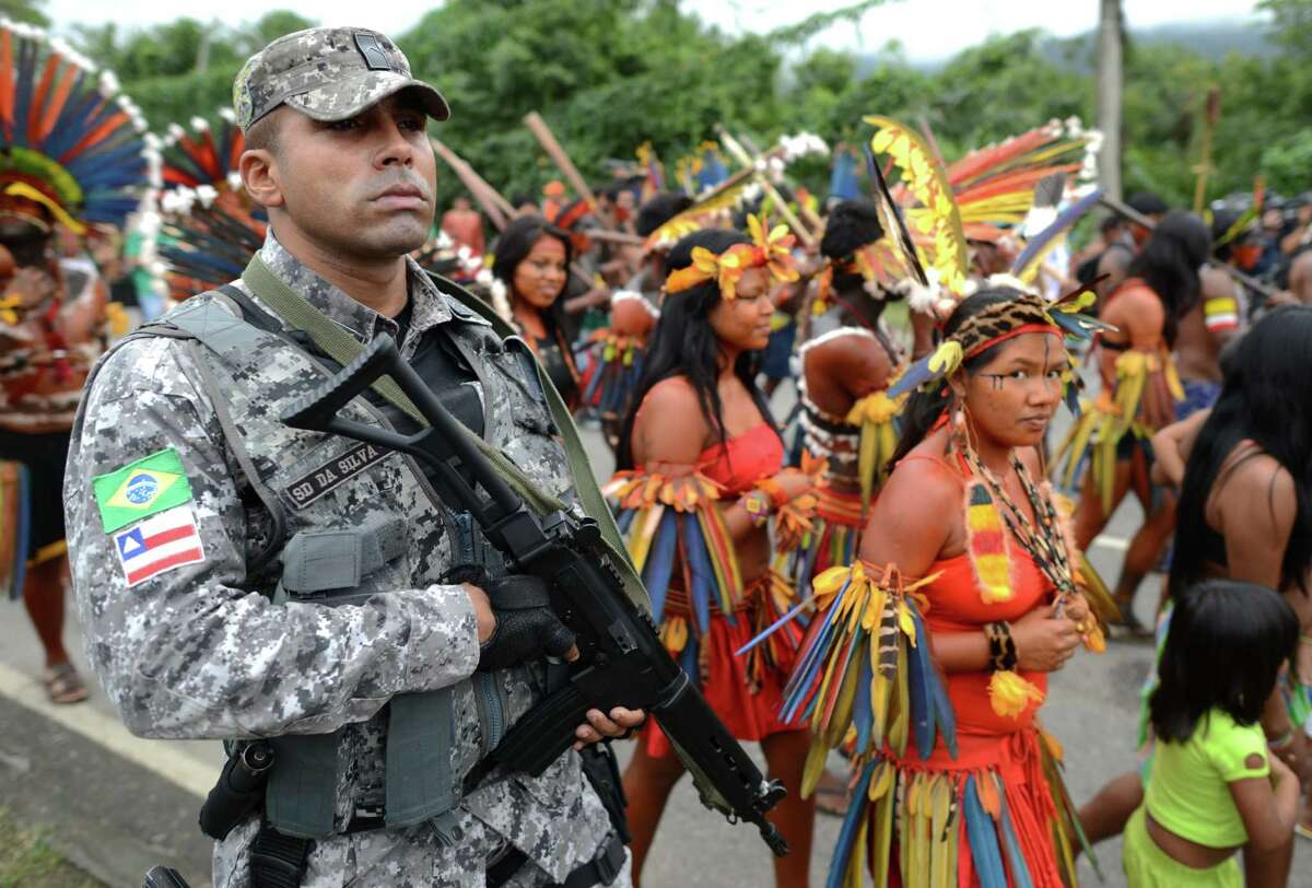 Brazilian Bororo natives walk upon arrival at RioCentro for the handing over of the Kari-Oca II Declaration to leaders attending the UN Conference on Sustainable Development, Rio+20, in Rio de Janeiro, Brazil, on June 21, 2012. World leaders attending the UN summit in Rio weighed steps to root out poverty and protect the environment as thousands of activists held several protests to denounce Amazon rainforest deforestation, the plight of indigenous peoples and the "green economy" being advocated at the UN gathering. AFP PHOTO / CHRISTOPHE SIMONCHRISTOPHE SIMON/AFP/GettyImages