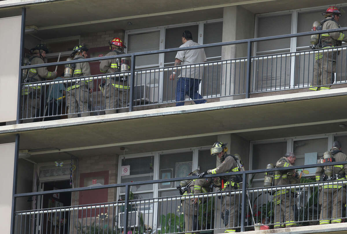 San Antonio firefighters gather on the seventh and eighth floors of the Victoria Plaza apartments at 411 Barrera Thursday June 21, 2012 after a small fire broke out in one of the apartment's bathrooms. Some residents were evacuated and according to traffic on the fire scanner the fire was extinguished with tap water.