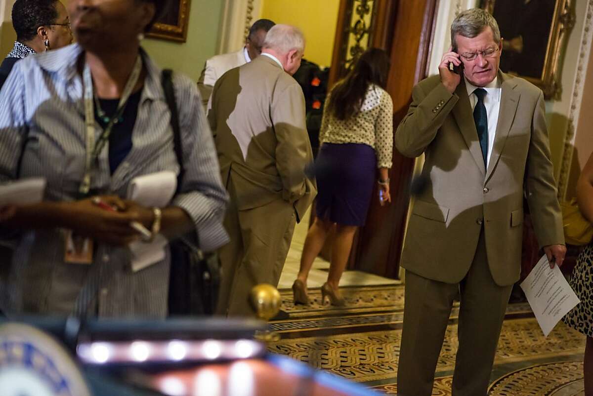 WASHINGTON - JUNE 21: Sen. Max Baucus (D-MT) talks on the phone before a news conferece on Capitol Hill on June 21, 2012 in Washington, DC. The Senate passed its version of the farm bill, which will now have to be merged with a House version before final passage. (Photo by Brendan Hoffman/Getty Images)
