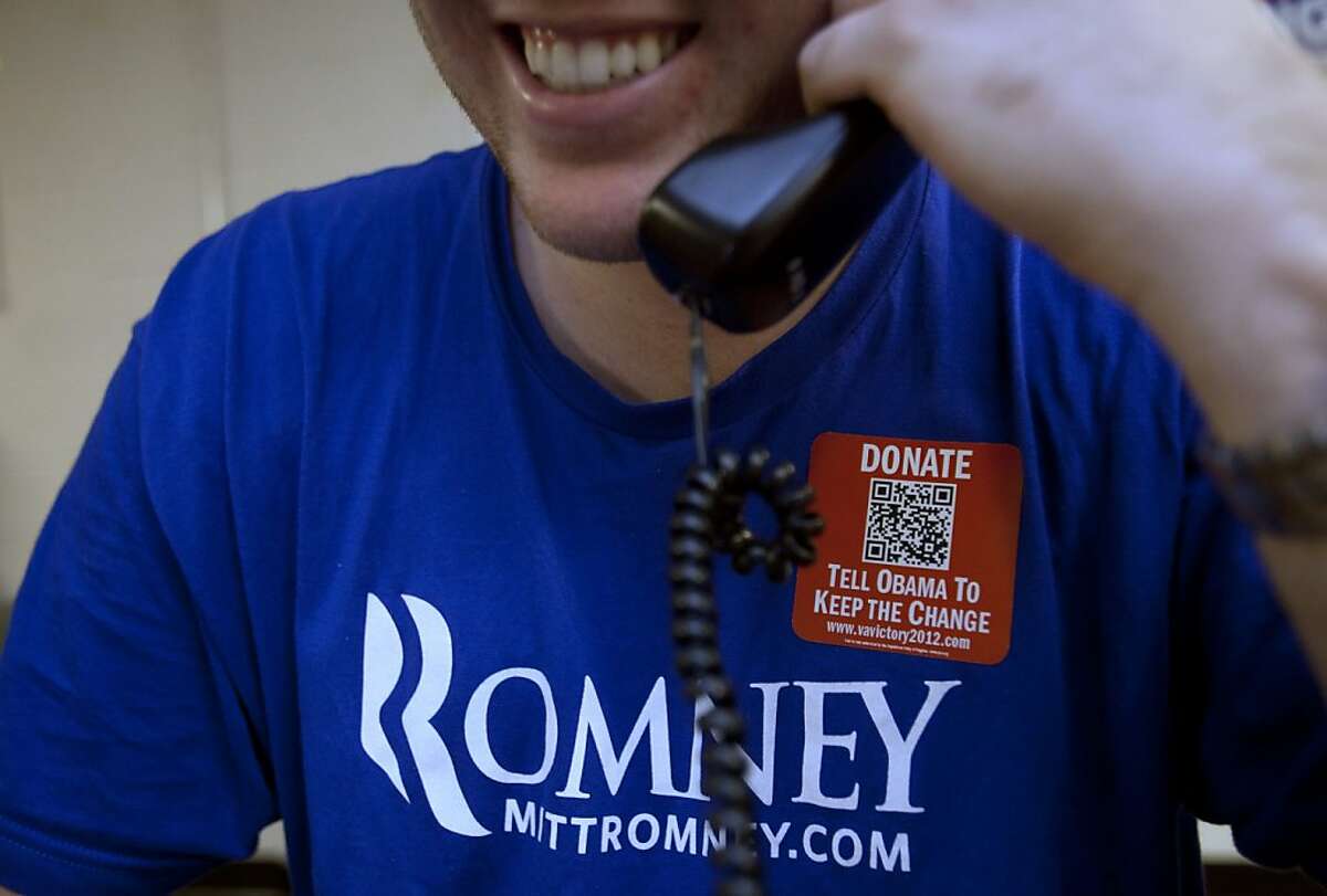 Bryan Munks, 19, of Arlington, Va., makes calls for the Romney campaign while wearing a quick response code sticker, or QR, in Fairfax, Va., on Tuesday, June 19, 2012. The presidential ground game has gone high tech, marrying old-school organizing work with innovative digital tools. The T-shirts that Romney campaign volunteers wear in Virginia feature a digital code that voters can zap with their smart phones to learn more about the Republican presidential hopeful, which gives Romney field organizers valuable information on how to reach them in the future.(AP Photo/Jacquelyn Martin)