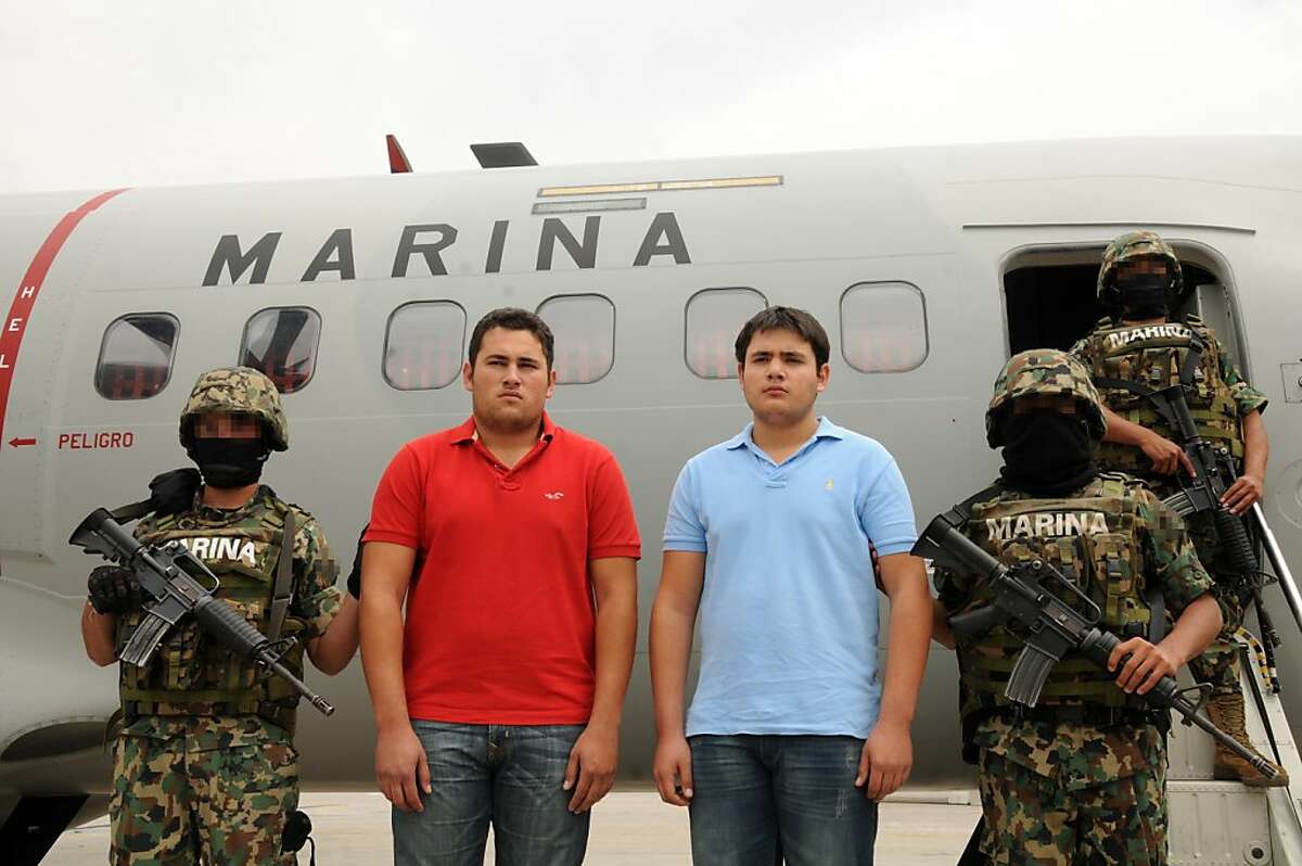 Handout picture released by the Mexican Navy showing the son of Joaquin Guzman Loera, aka "El Chapo Guzman", leader of the Pacific drug cartels, Jesus Alfredo Guzman Salazar (2-L) and alleged drug trafficker Kevin Beltran Rios (2-R) being escorted by marines in Mexico City, on June 21, 2012. Guzman Salazar was arrested by the Mexican marines on Thursday in an operation in Zapopan, Jalisco State. AFP PHOTO/MEXICAN NAVY --- RESTRICTED TO EDITORIAL USE - MANDATORY CREDIT "AFP PHOTO/MEXICAN NAVY" - NO MARKETING NO ADVERTISING CAMPAIGNS - DISTRIBUTED AS A SERVICE TO CLIENTS--/AFP/GettyImages