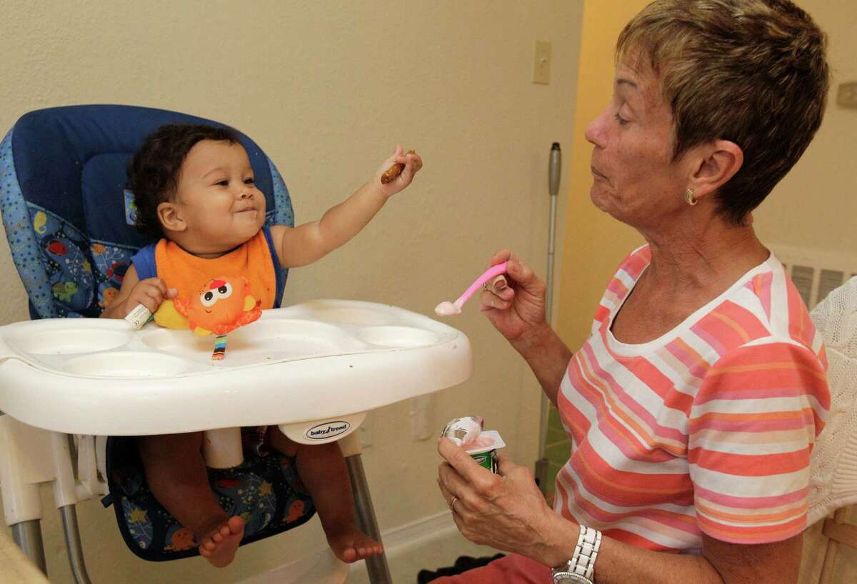 Patricia Hansen feeds her 11-month-old grandson, Jonathan Chabot, at home after she and her husband, Michael Hansen, were granted a permanent managing conservatorship of Jonathan in the 315th Juvenile District Court, Wednesday, June 20, 2012, in Houston. Jonathan, who tested positive for drugs when he was born, has lived with his grandparents since he was released from the hospital. The Hansen's gave up their retirement dreams of living in Belize to come back to care for Jonathan.
