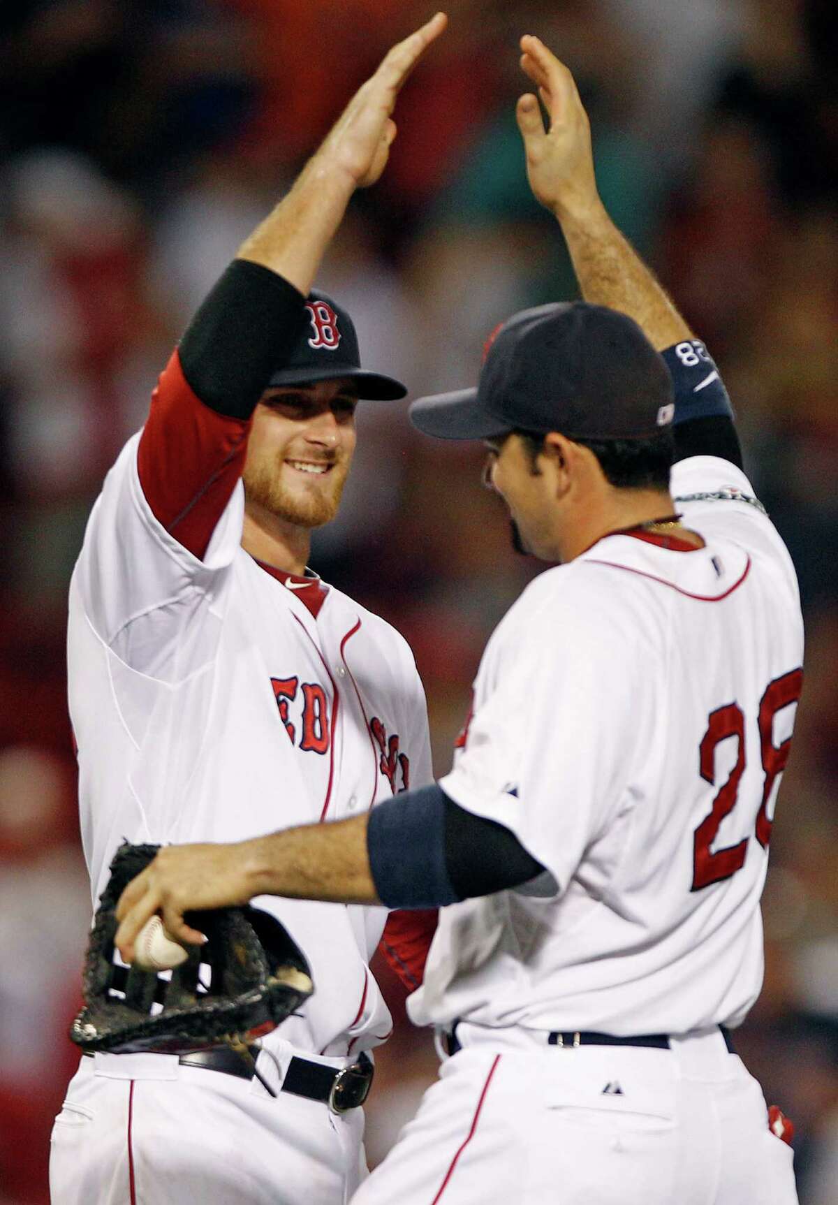 Boston Red Sox third baseman Will Middlebrooks, left, is congratulated by Adrian Gonzalez after their 6-5 win over the Miami Marlins in a baseball game at Fenway Park in Boston, Thursday, June 21, 2012.