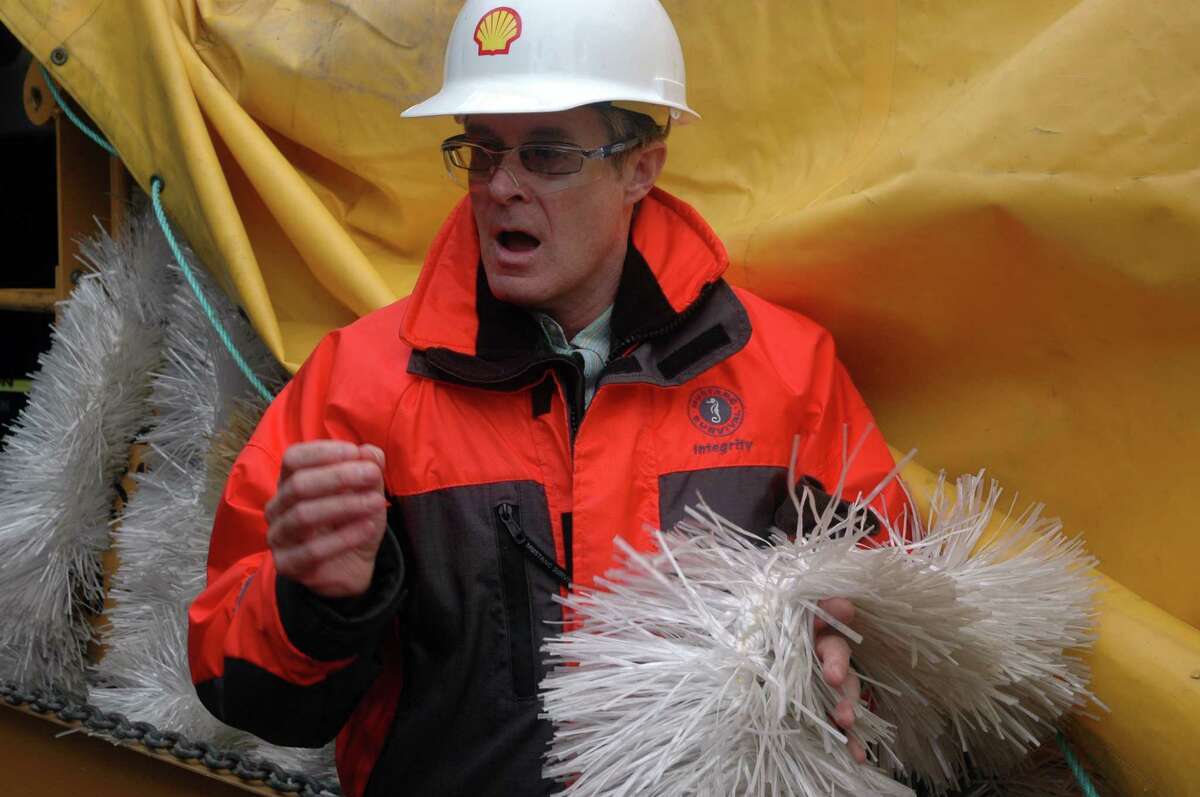 Geoff Merrell, superintendent of emergency response for Shell Alaska, holds skimmer brushes that would be used in case of an oil spill.