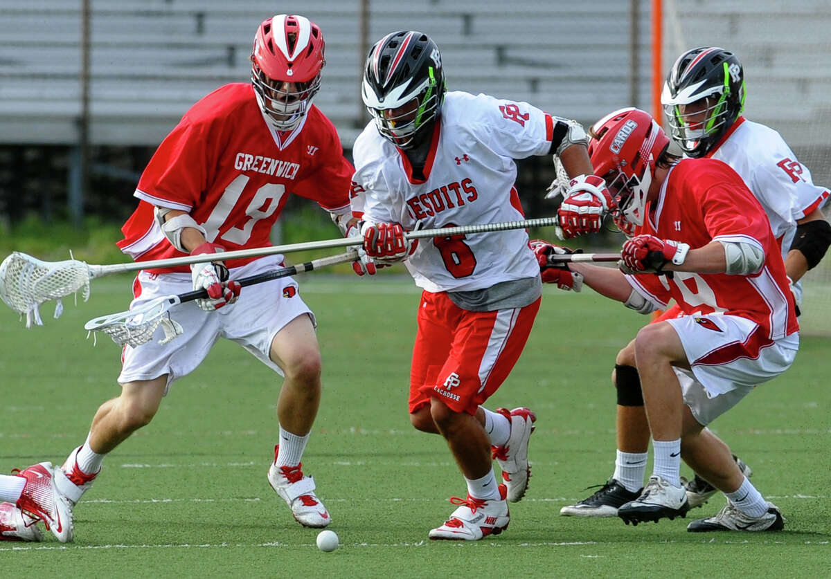 Fairfield Prep's #6 Andrew Hatton, center, goes after a loose ball, during the first round of Division L boys lacrosse state tournament action in Fairfield, Conn. on Wednesday May 30, 2012. Greenwich's #18 Kelley Jay, left, and teammate #29 Graham Savio come in from behind.
