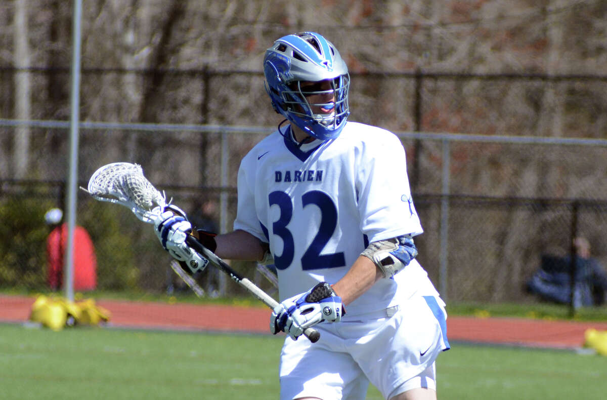 Darien's Henry West (32) takes a shot during the boys lacrosse game against Staples at Darien High School on Saturday, Apr. 7, 2012.