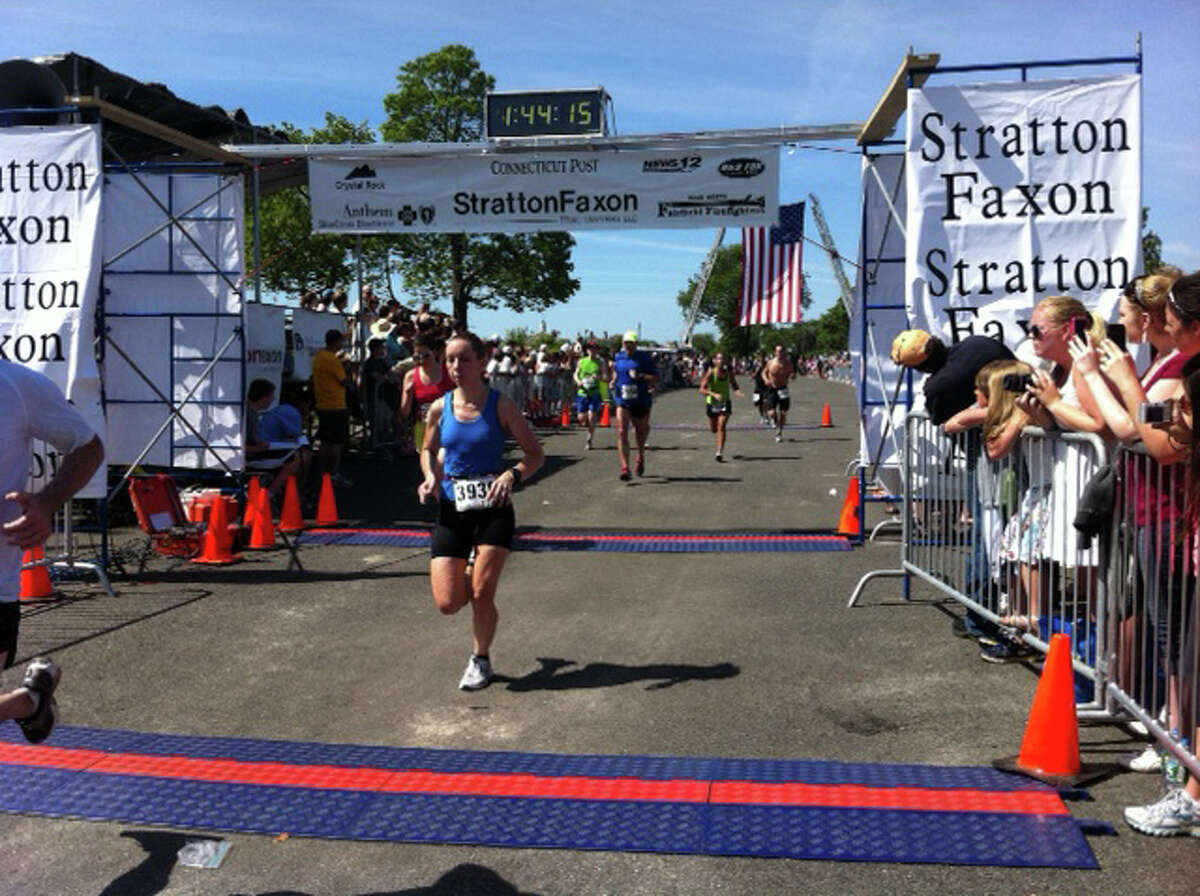 A runner crosses the Jennings Beach finish line Sunday morning the Stratton Faxon Fairfield Road Races.