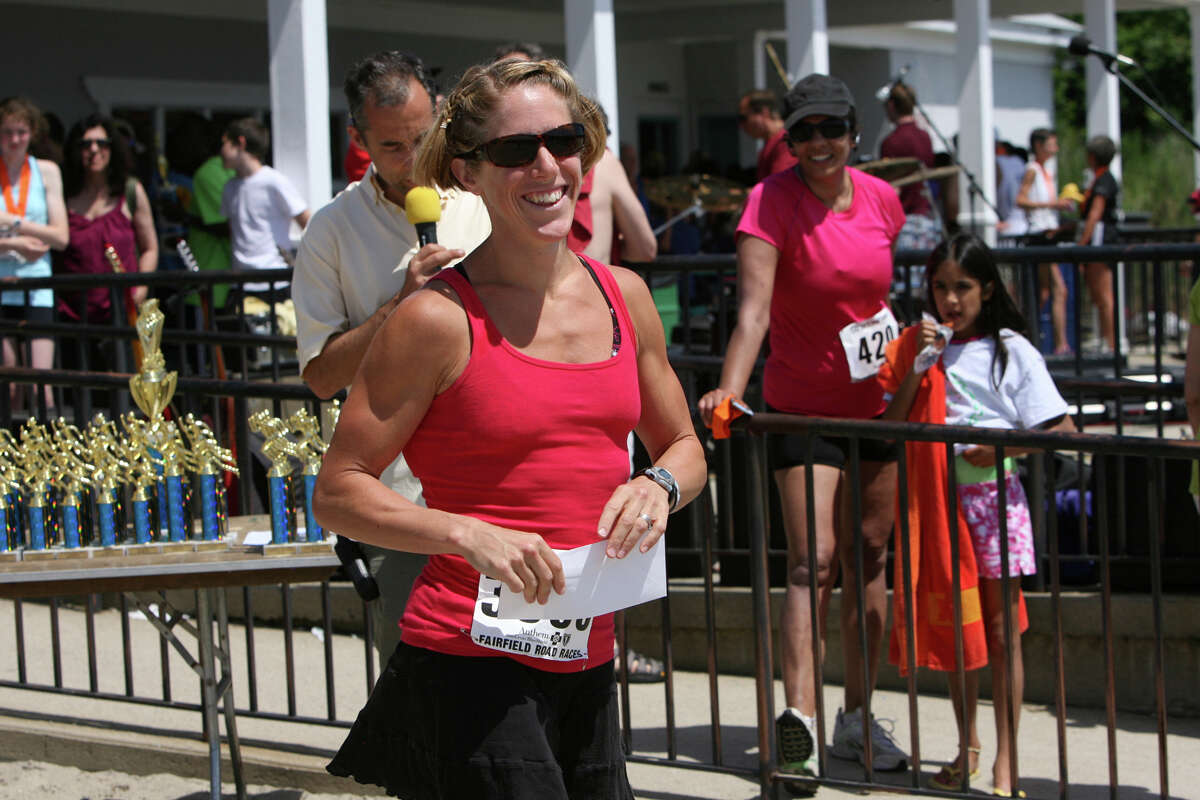 Amy Bevilacqua, of Wilton, receives a prize at the annual Stratton Faxon Fairfield Half Marathon in Fairfield, Conn. on Sunday, June, 24, 2012. Bevilacqua was the first woman from Conn. to finish.