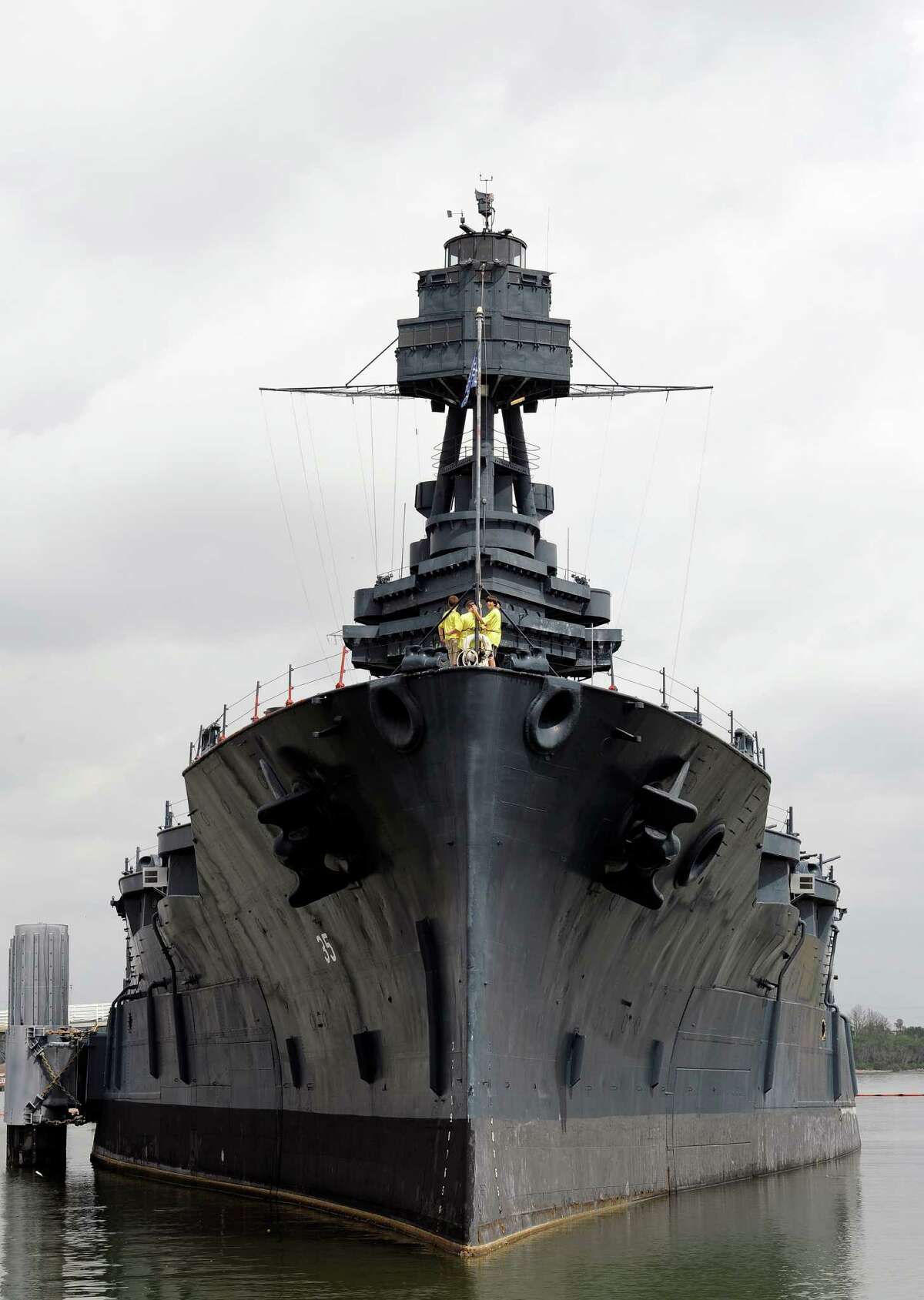 In this June 13, 2012 file photo, tourists visit the deck of the USS Battleship Texas as she lists slightly on the port side, in Houston. The 100-year-old museum is closed indefinitely after several leaks flooded the vessel that fought in World Wars I and II.