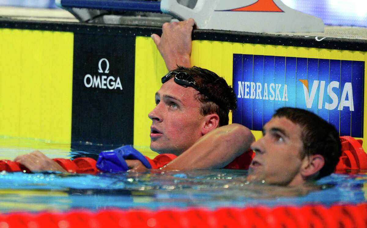 Ryan Lochte, left, and Michael Phelps watch the results in the men's 400-meter individual medley final at the U.S. Olympic swimming trials, Monday, June 25, 2012, in Omaha, Neb. Lochte won the race. (AP Photo/Mark J. Terrill)