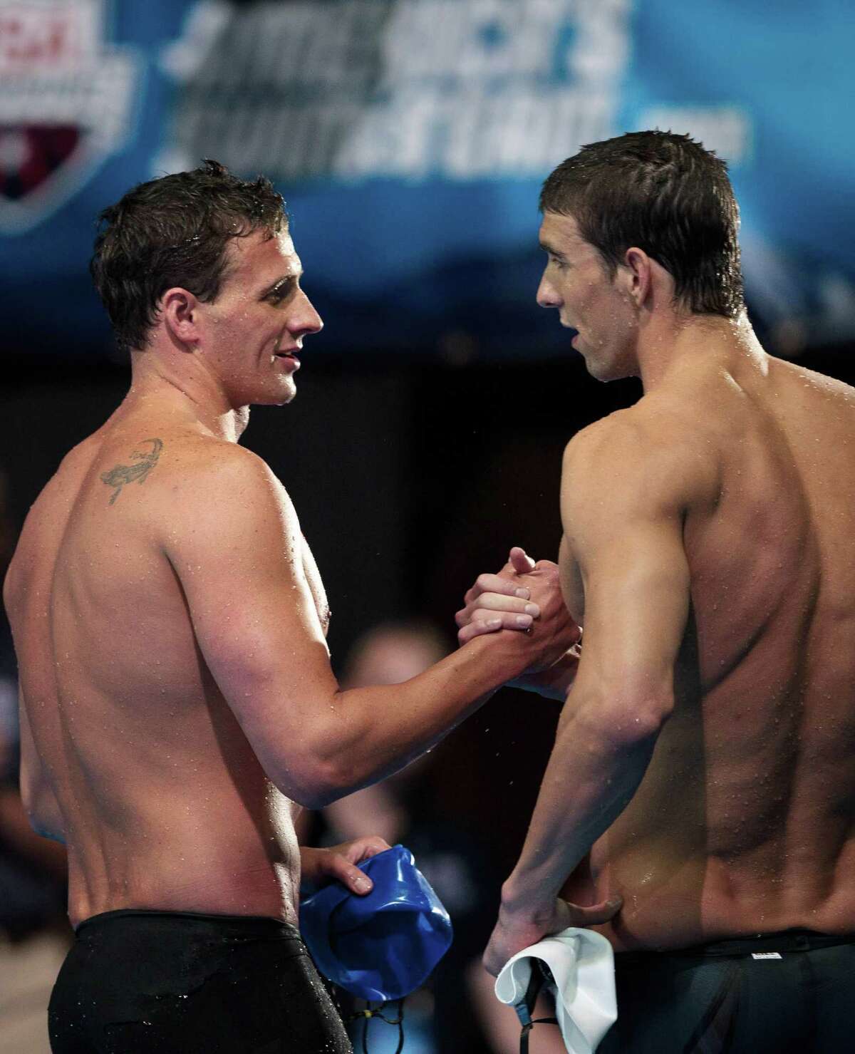 Ryan Lochte, left and Michael Phelps embrace after swimming in the men's 400-meter individual medley final at the U.S. Olympic swimming trials, Monday, June 25, 2012, in Omaha, Neb. Lochte won the race. (AP Photo/The Omaha World-Herald/Matt Miller) MAGS OUT TV OUT