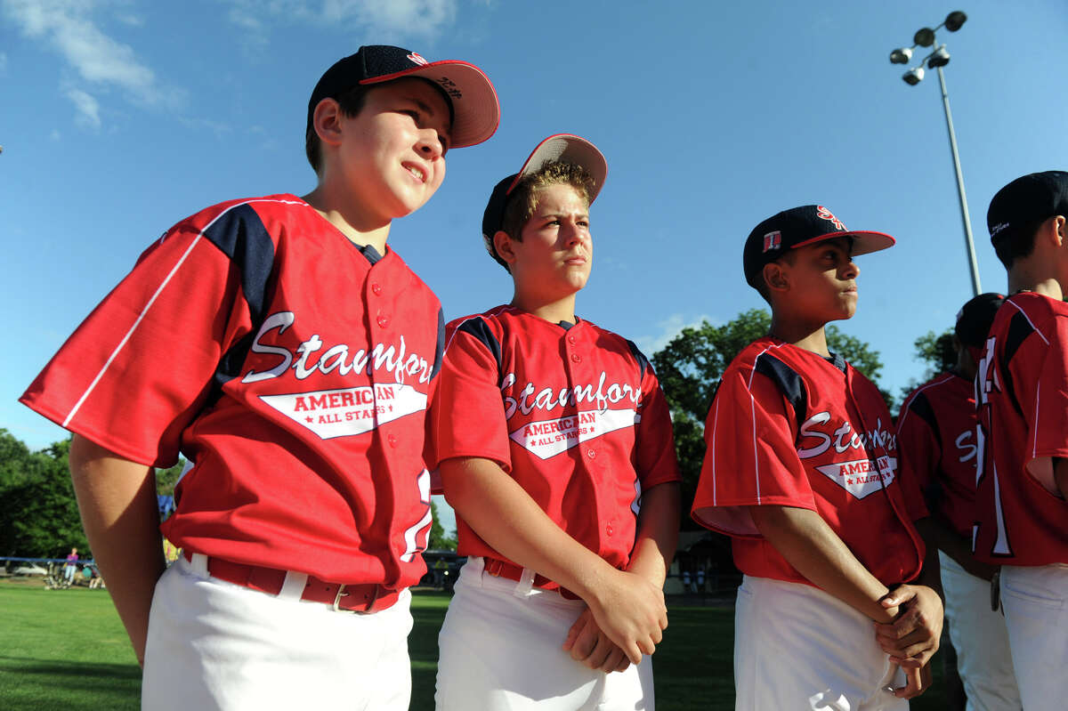 Chris Connolly, Chris Bell and Chris Rojas and teammates from the Stamford American Little League team attend the Little League Opening Ceremonies at Springdale's Drotor Field in Stamford, Conn., June 26, 2012.