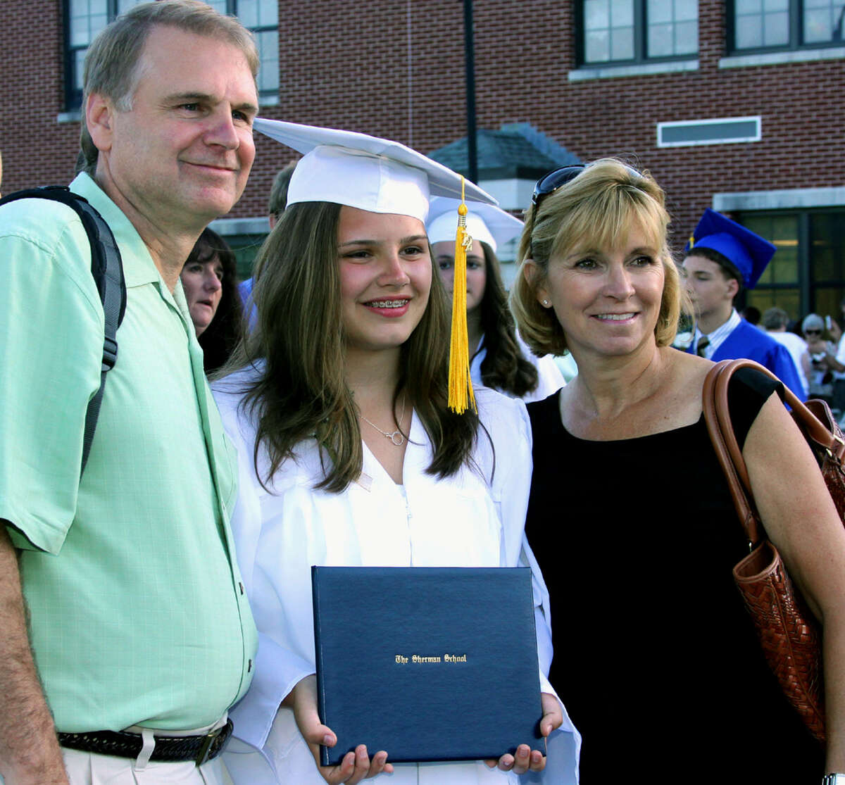 Paul and Karen Cardillo share a special moment with their graduate daughter, Claire, following the Sherman School graduation exercises, June 15, 2012