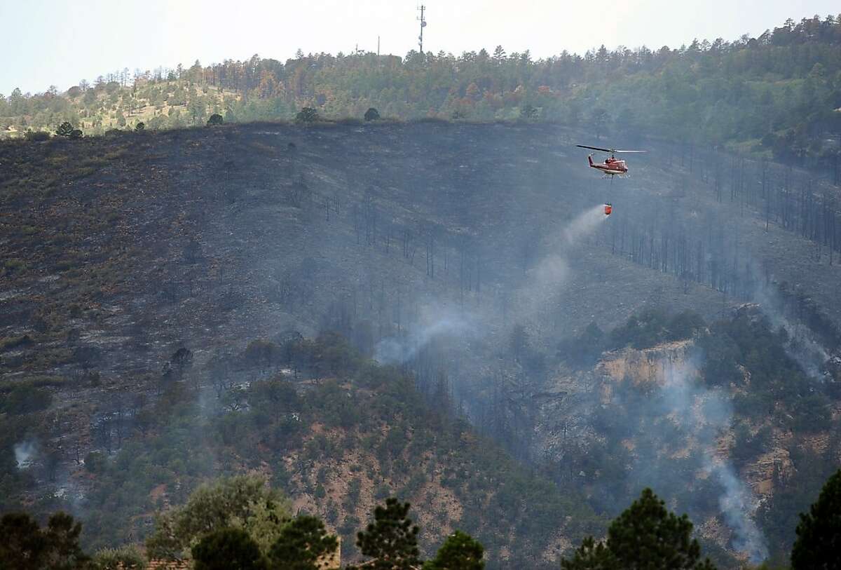 Colorado Springs crews fight wildfire near homes
