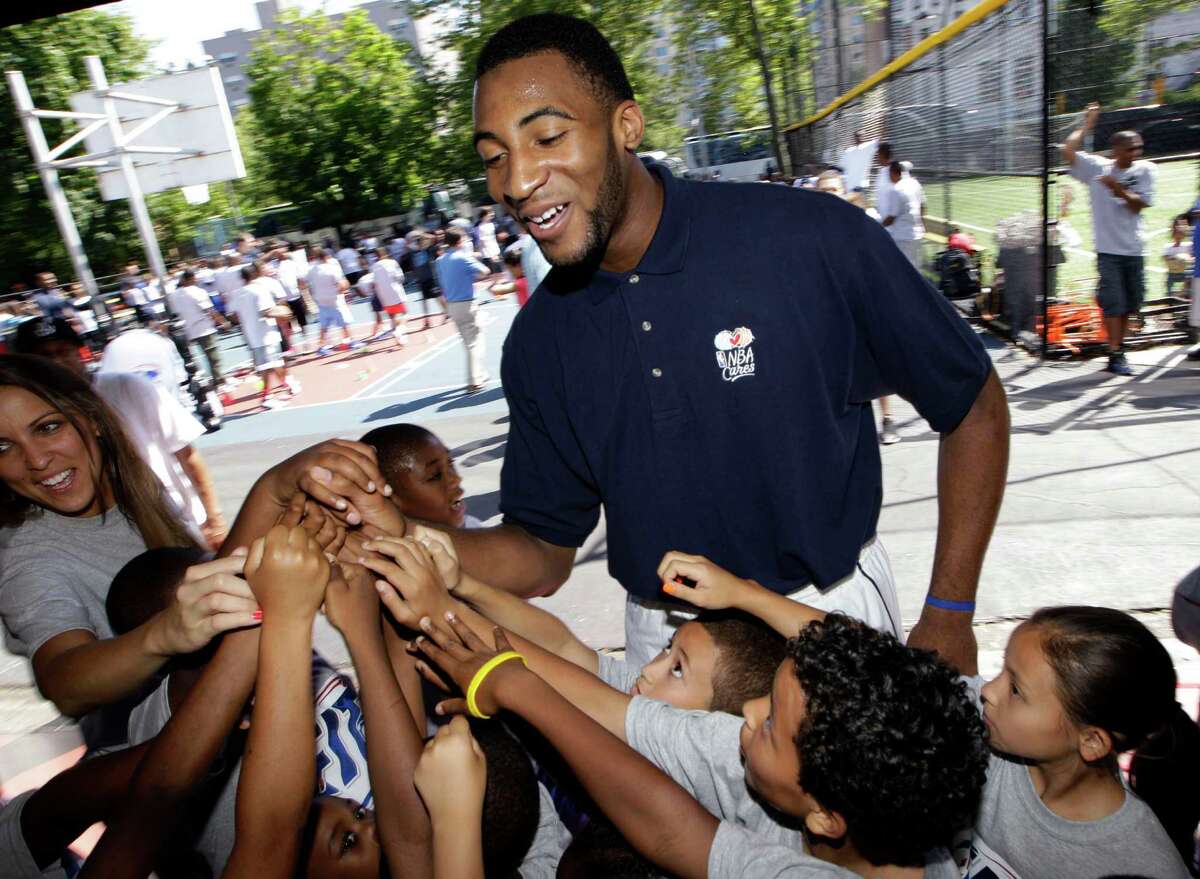 NBA Draft prospect Andre Drummond gathers with youngsters during an NBA fitness clinic at the Children's Aid Society Dunlevy Milbank Boys & Girls Club in the Harlem section of New York, Wednesday, June 27, 2012. (AP Photo/Kathy Willens)