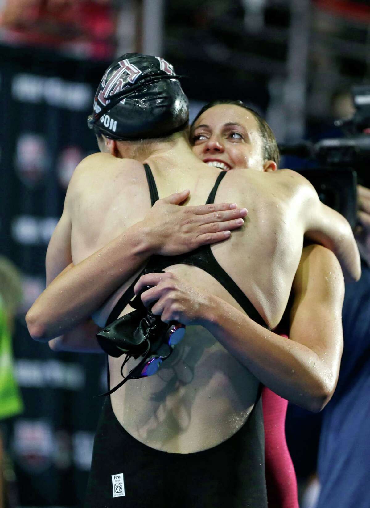 Breeja Larson, left, hugs Rebecca Soni after winning the women's 100-meter breaststroke final at the U.S. Olympic swimming trials on Wednesday, June 27, 2012, in Omaha, Neb. (AP Photo/Mark Humphrey)