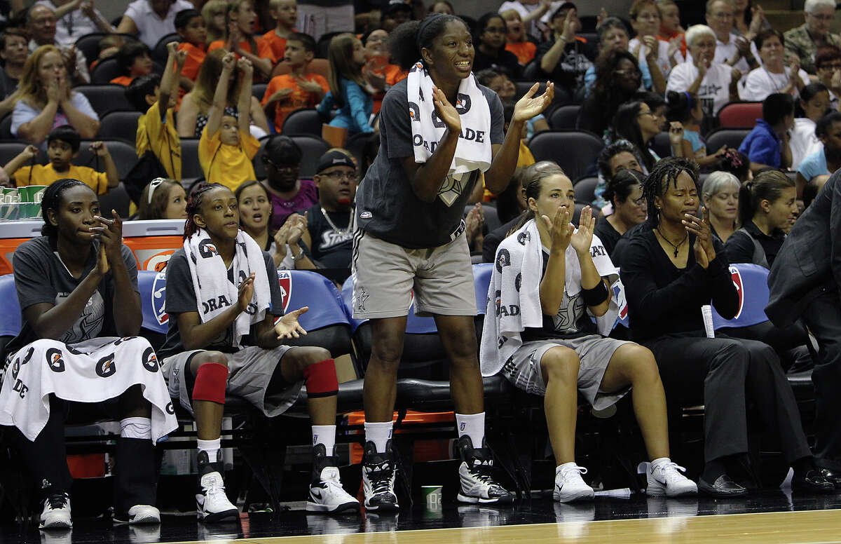 The Silver Stars starters Sophia Young (from left), Danielle Robinson, Shameka Christon and Becky Hammon root on their teammates in the closing moments of their game against the Los Angeles Sparks in the second half at the AT&T Center on Thursday, June 28, 2012. Silver Stars defeated the Sparks, 94-80.