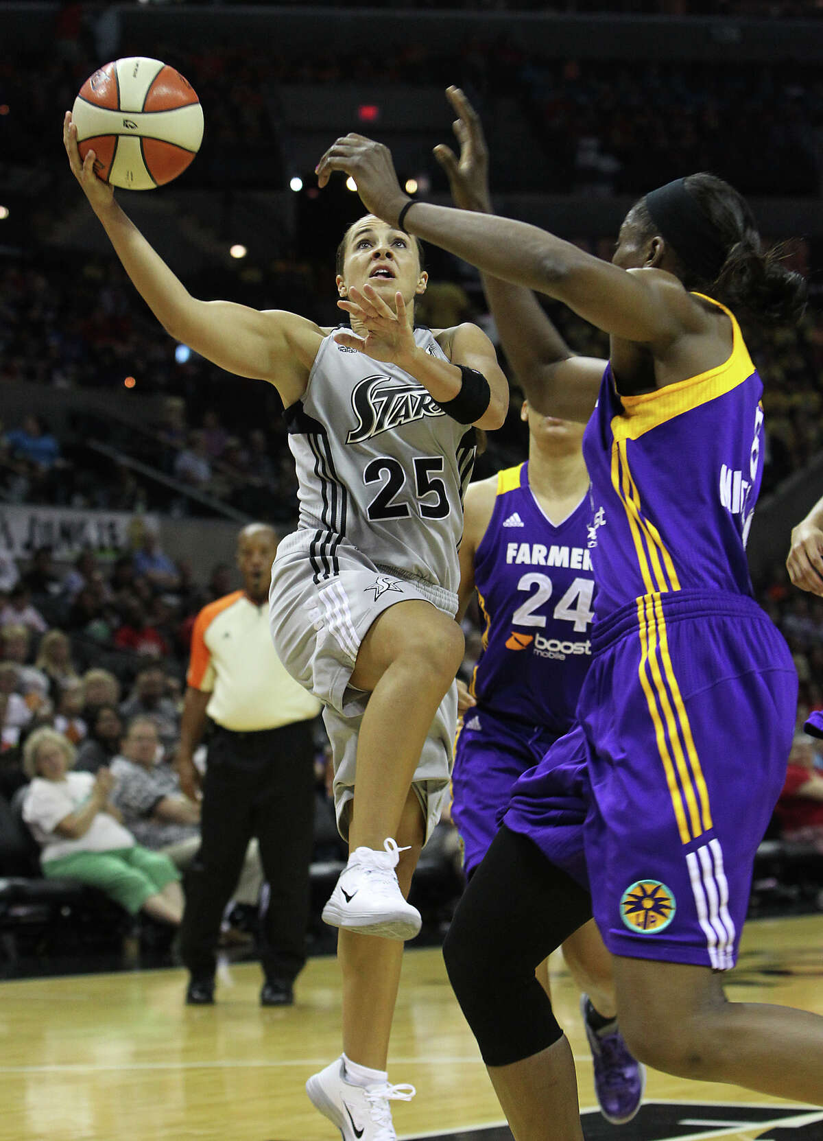 Silver Stars' Becky Hammon (25) goes up for a shot against the Los Angeles Sparks' DeLisha Milton-Jones (08) in the first half at the AT&T Center on Thursday, June 28, 2012.