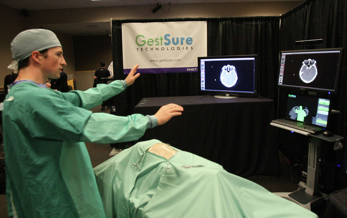 Dr. Matt Strickland, co-founder and chief medical officer of GestSure Technologies, demonstrates his company's system, which lets surgeons touchlessly view and manipulate medical scans and images, at the Microsoft Accelerator for Kinect exhibition in Redmond on Thursday, June 28, 2012. Currently, surgeons have to get a nurse to manipulate such information, because it's not sterile, Strickland said. "It's very awkward. You want to be doing it with your own hands."