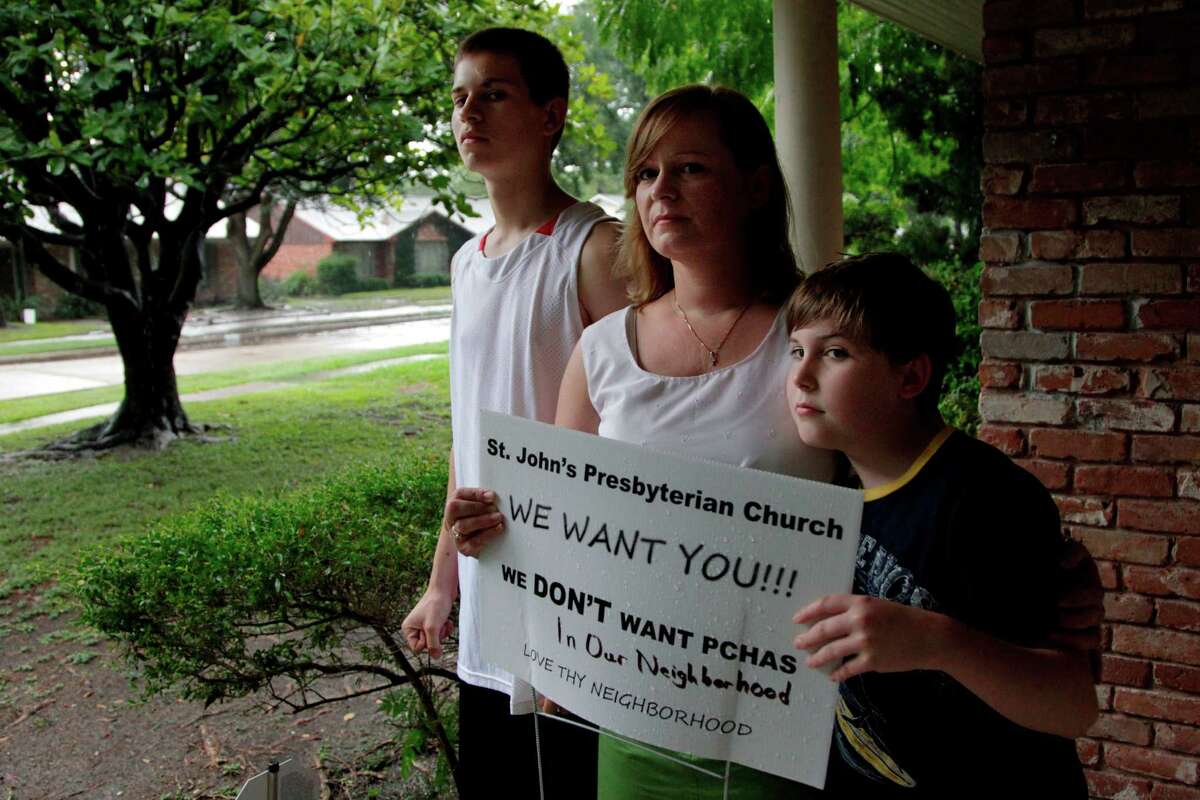 Tammy Bowles, with sons Dylan Ubanoski, 16, left, and Marc Bowles, 9, opposes a shelter that would be occupied by seven single-parent families.