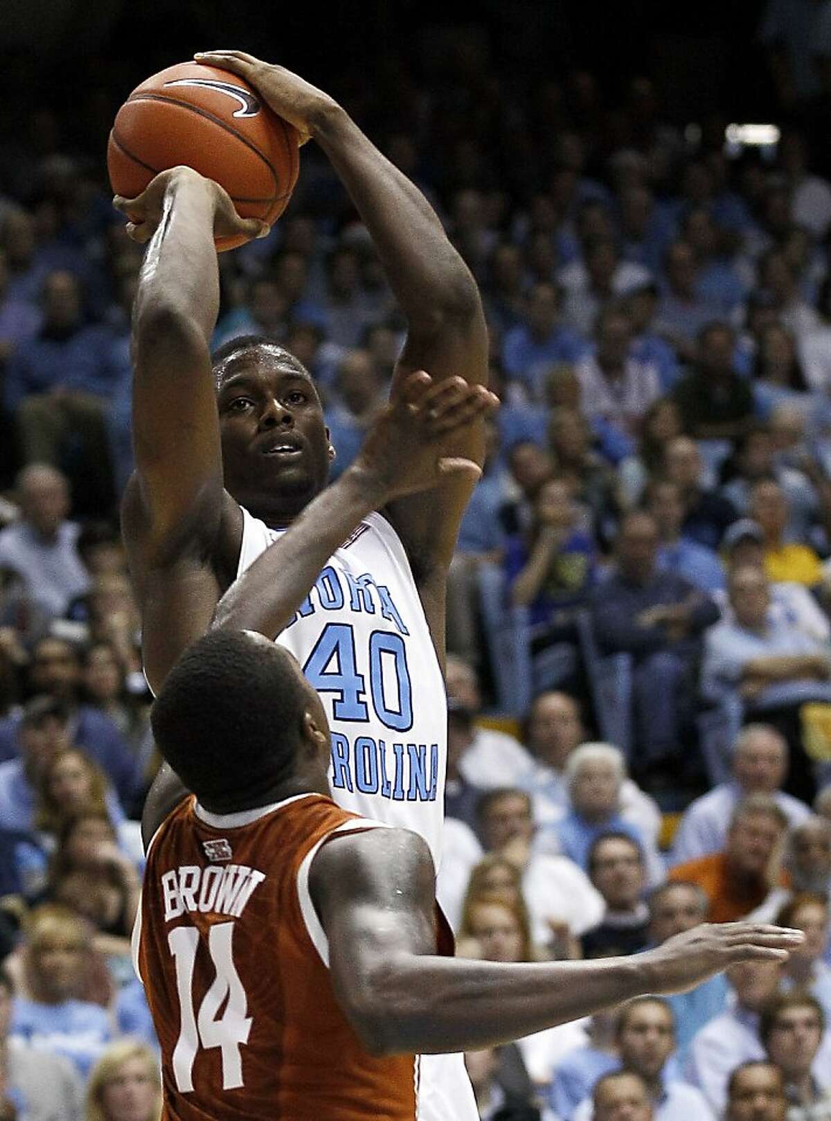 North Carolina's Harrison Barnes (40) shoots as Texas' J'Covan Brown (14) defends during the second half of an NCAA college basketball game in Chapel Hill, N.C., Wednesday, Dec. 21, 2011. North Carolina won 82-63. (AP Photo/Gerry Broome)