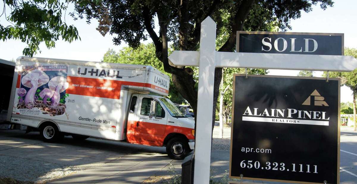 A moving truck is shown at a house that was sold in Palo Alto, Calif., Tuesday, June 19, 2012. In 2021, people moved at the lowest rate in over 70 years, according to the U.S. Census Bureau. (AP Photo/Paul Sakuma)