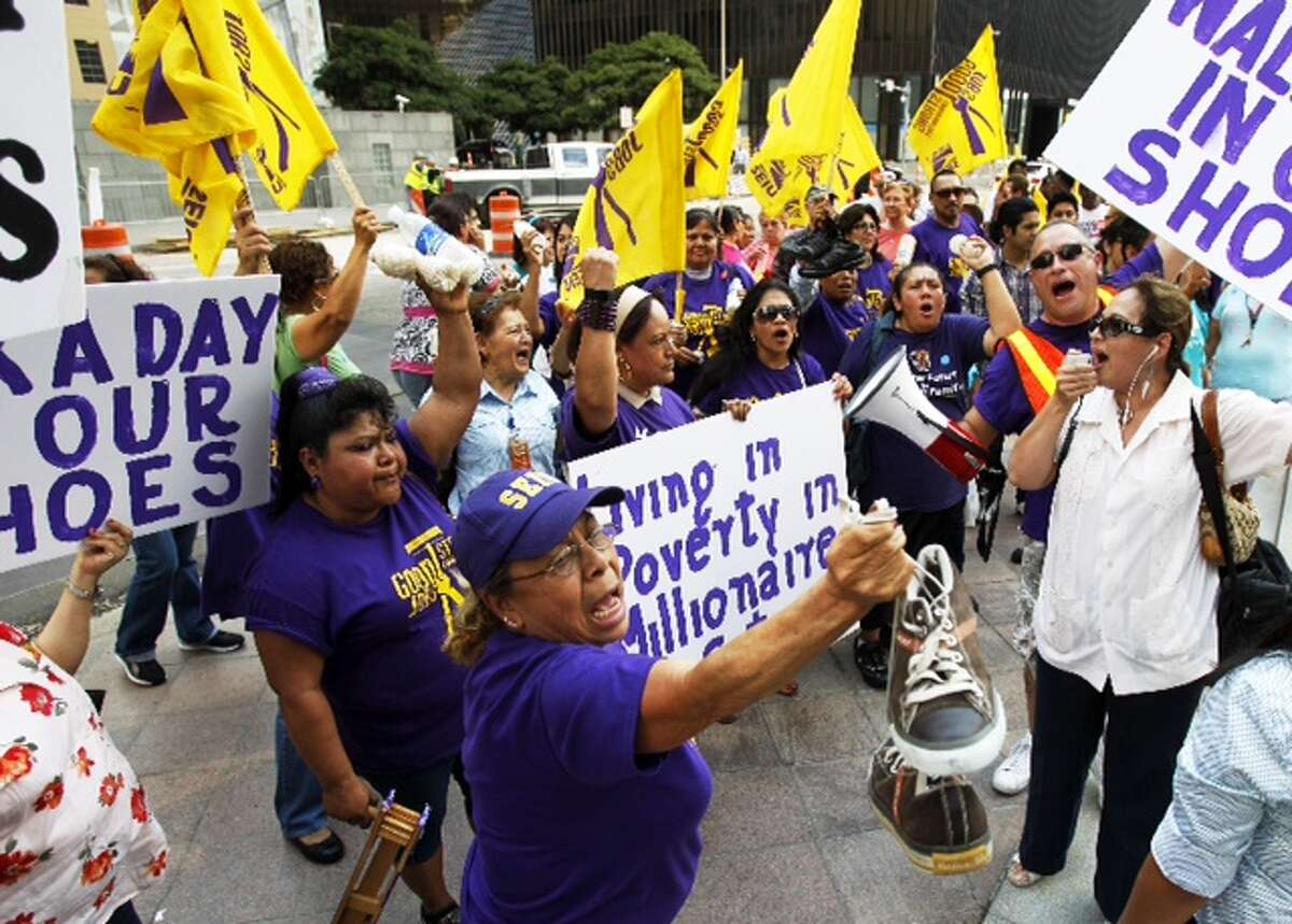Janitors seeking a pay raise from cleaning contractors demonstrate in downtown Houston.