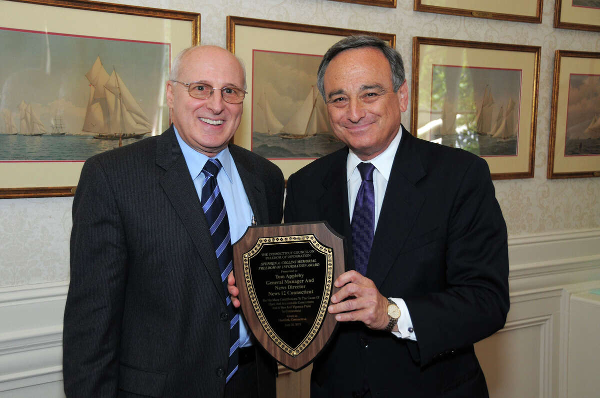 Connecticut Council on Freedom of Information Legislative Chair G. Claude Albert, left, presents the Stephen A. Collins Award to Tom Appleby, general manager and news director of News Connecticut 12, at the CCFOIís annual lunch at the Hartford Club in Hartford, Conn., on June 20, 2012.
