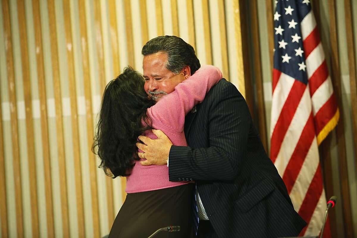 Superintendent Carlos Garcia is getting hugged by one of the board members after his emotional speech during his last school board meeting in San Francisco, Calif. on Tuesday, June 26, 2012.